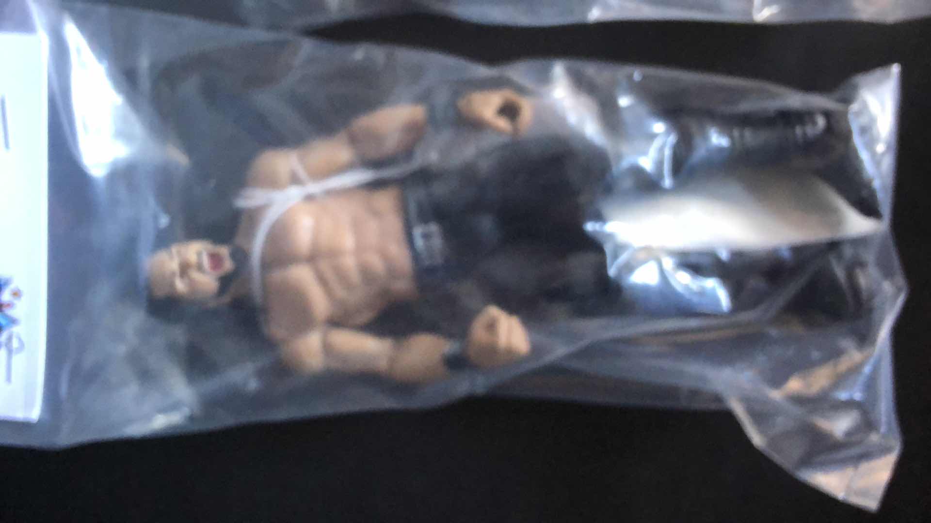 Photo 1 of ASSORTMENT OF UNBOXED WRESTLING ACTION FIGURES (4)