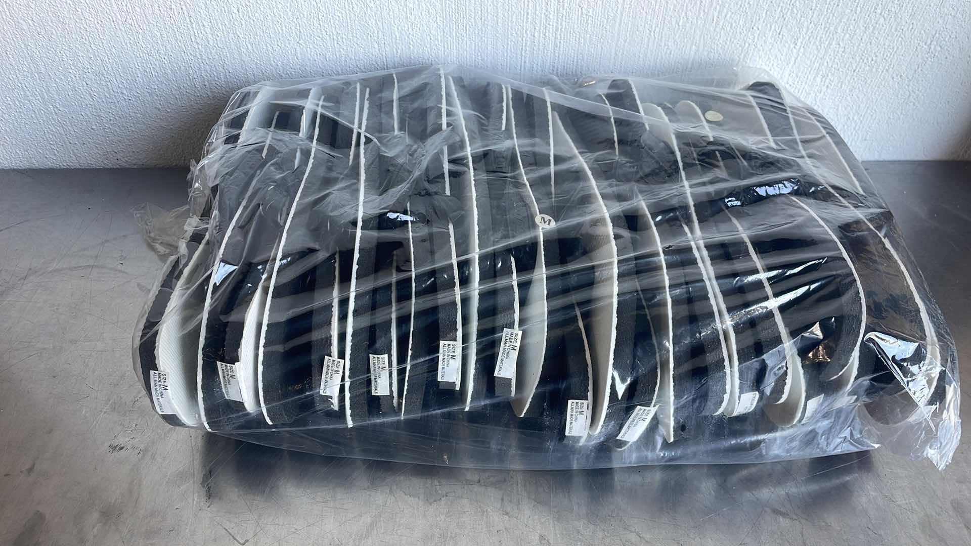 Photo 1 of BLACK AND WHITE THONGS/FLIP FLOPS SIZE MEDIUM (12)