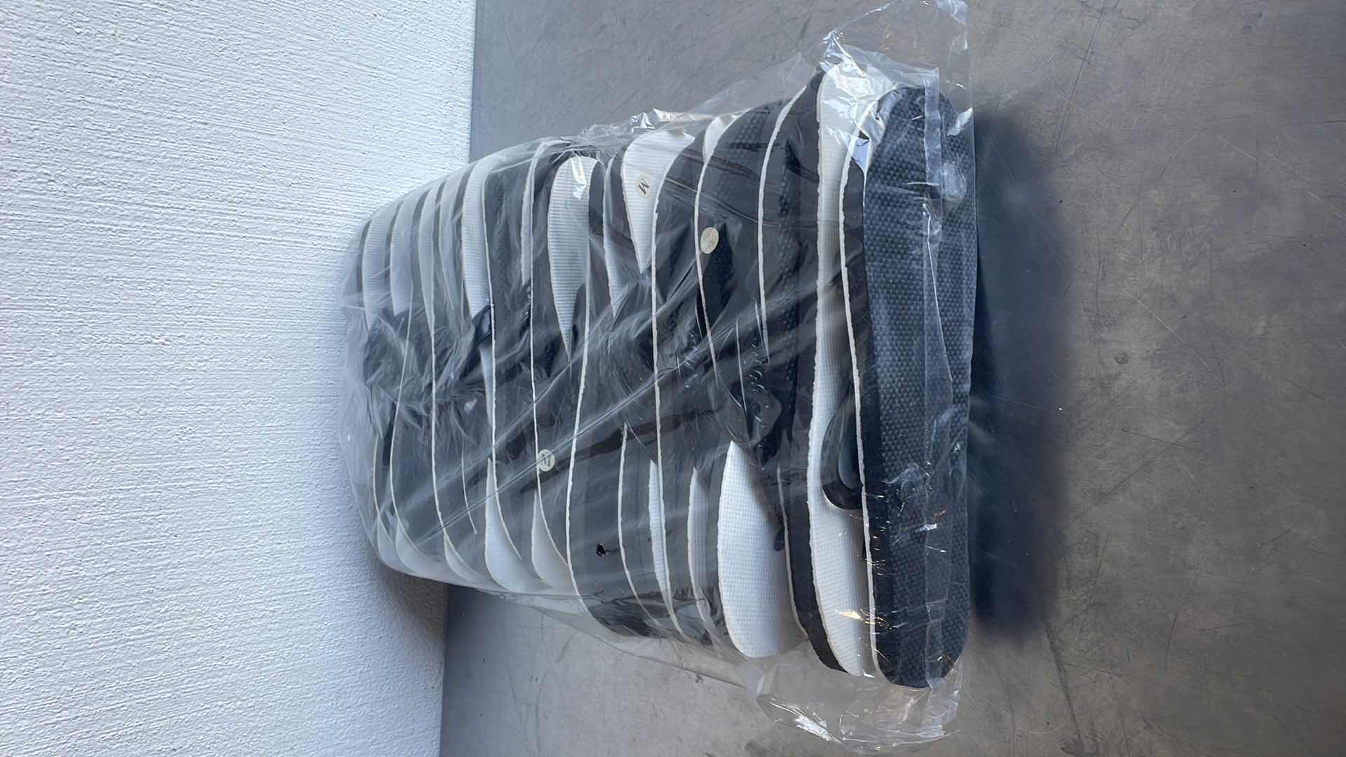 Photo 1 of BLACK AND WHITE THONGS/FLIP FLOPS SIZE MEDIUM (12)