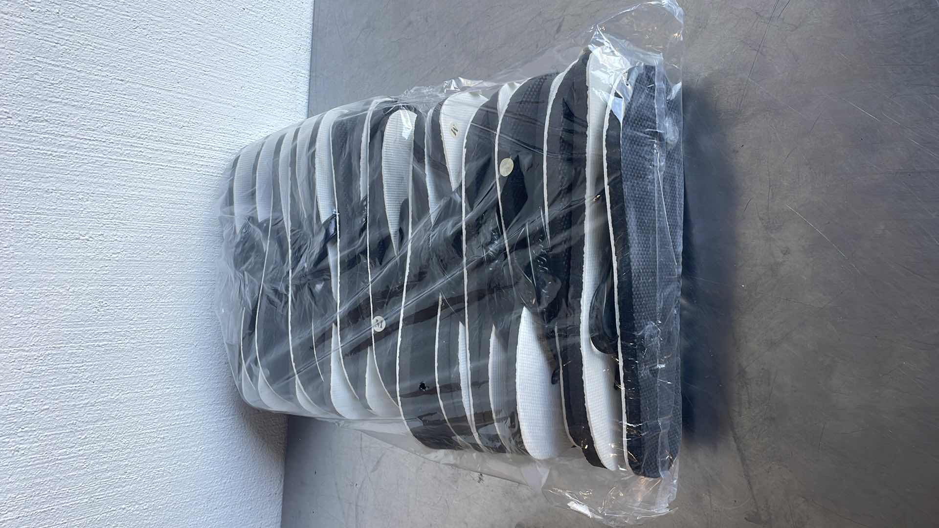 Photo 1 of BLACK AND WHITE THONGS/FLIP FLOPS SIZE MEDIUM (12)