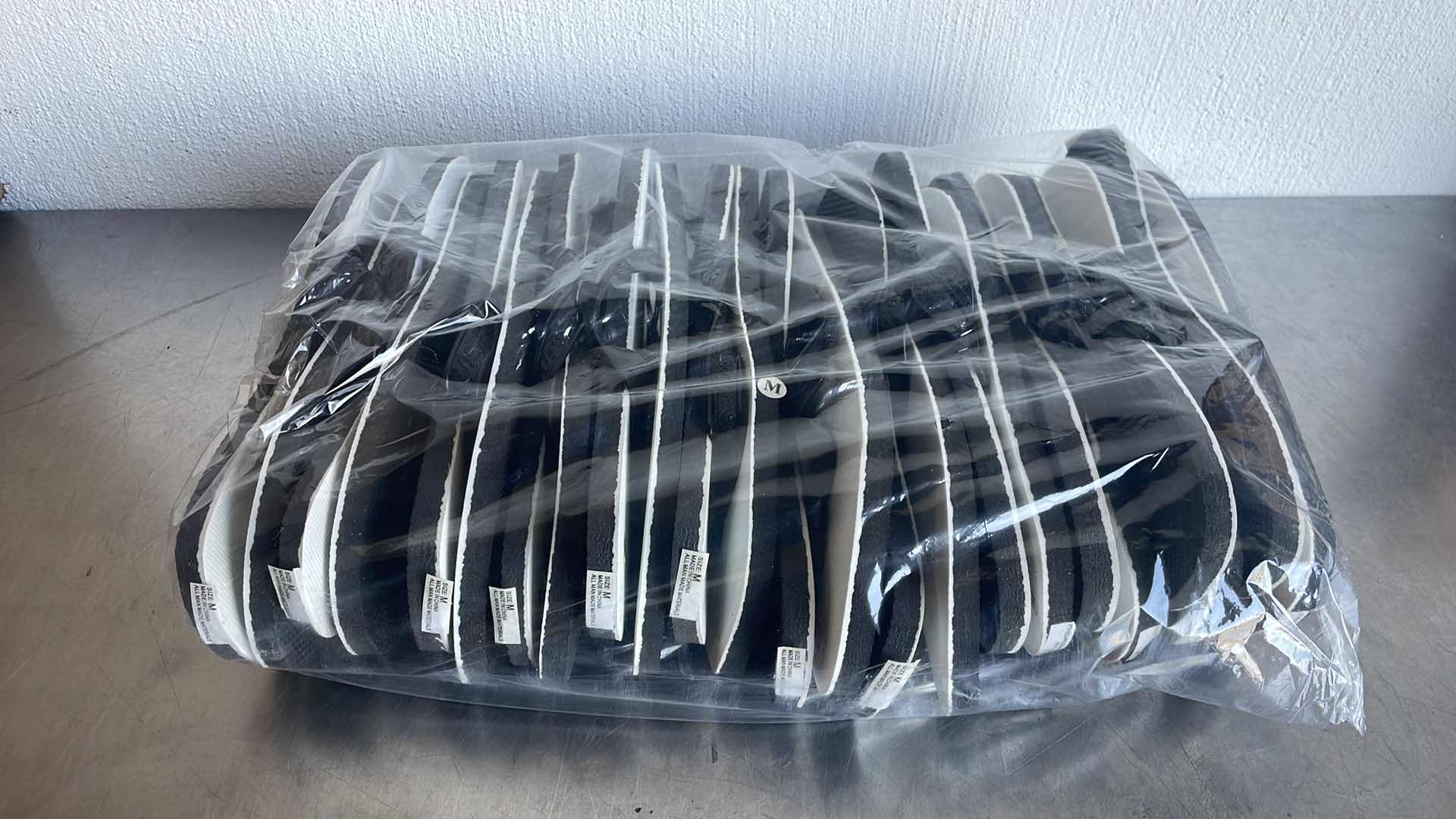 Photo 1 of BLACK AND WHITE THONGS/FLIP FLOPS SIZE MEDIUM (12)