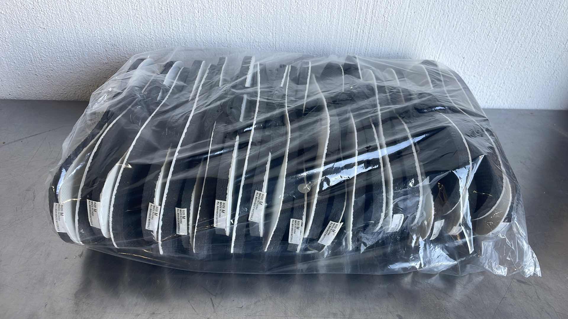 Photo 1 of BLACK AND WHITE THONGS/FLIP FLOPS SIZE MEDIUM (12)