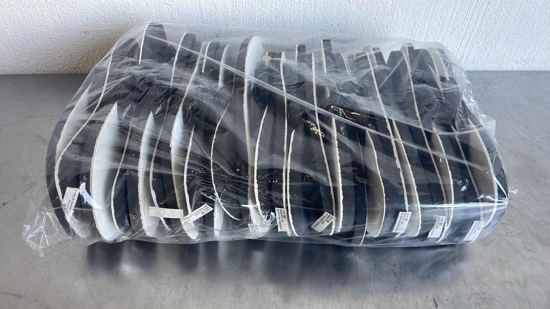 Photo 1 of BLACK AND WHITE THONGS/FLIP FLOPS SIZE MEDIUM (12)