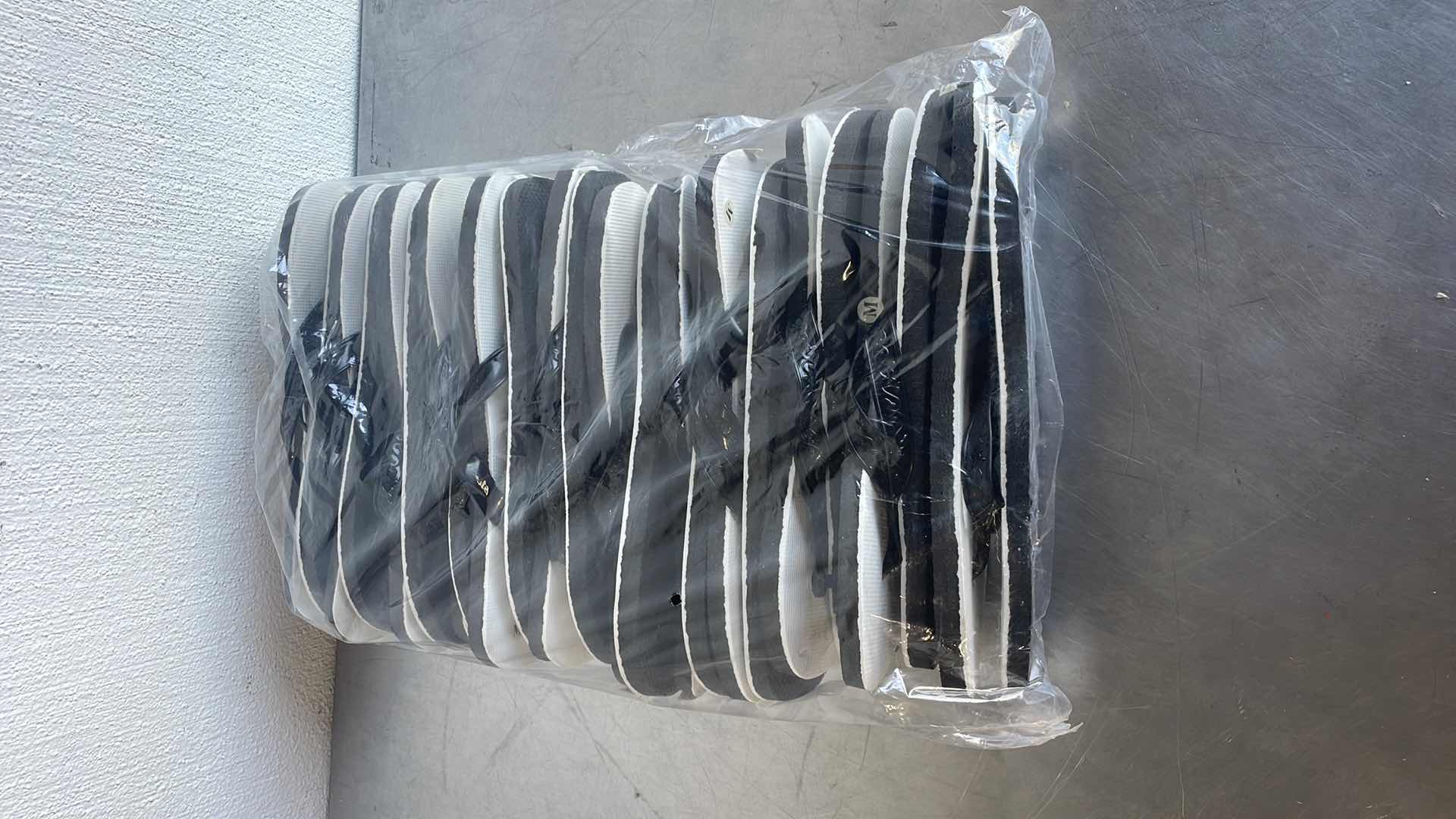 Photo 1 of BLACK AND WHITE THONGS/FLIP FLOPS SIZE MEDIUM (12) SHOWER SHOES