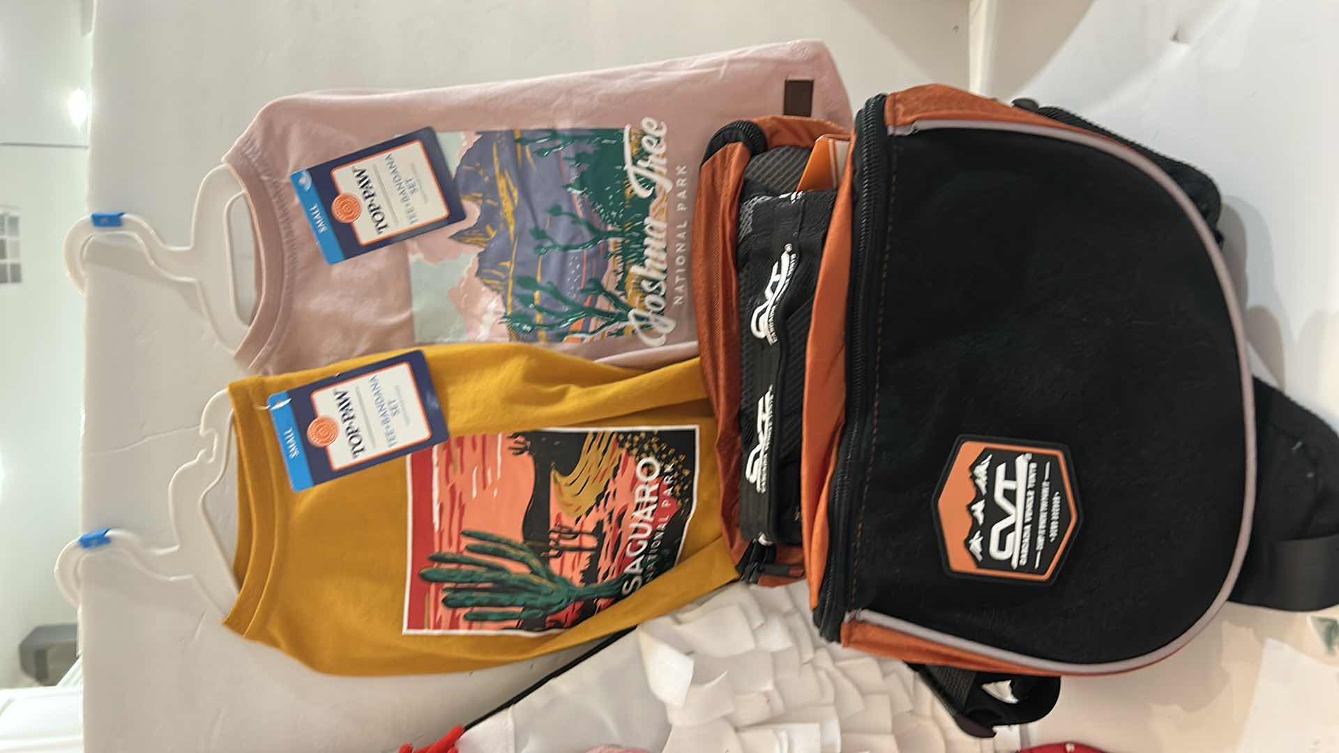 Photo 1 of NEW SMALL DOG ASSORTMENT, 1 BACKPACK/SADDLE BAG, 2 TOP PAW TEE SHIRTS, 4 COLLARS, 1 TOP PAW DOG HAT AND A SNUFFLE MAT