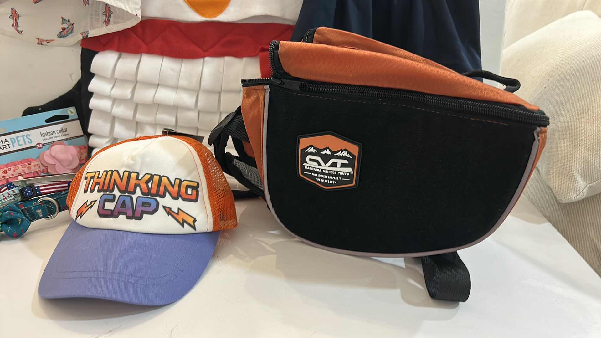 Photo 1 of NEW SMALL DOG ASSORTMENT, 1 BACKPACK/SADDLE BAG, 2 TOP PAW SHIRTS, 4 COLLARS, 1 TOP PAW DOG HAT AND A SNUFFLE MAT