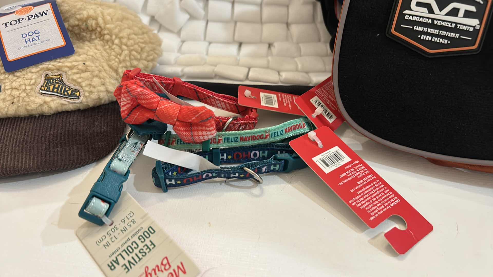 Photo 1 of NEW SMALL DOG ASSORTMENT, 1 BACKPACK/SADDLE BAG, 2 TOP PAW TEE SHIRTS, 4 XS COLLARS, 1 TOP PAW DOG HAT AND A SNUFFLE MAT