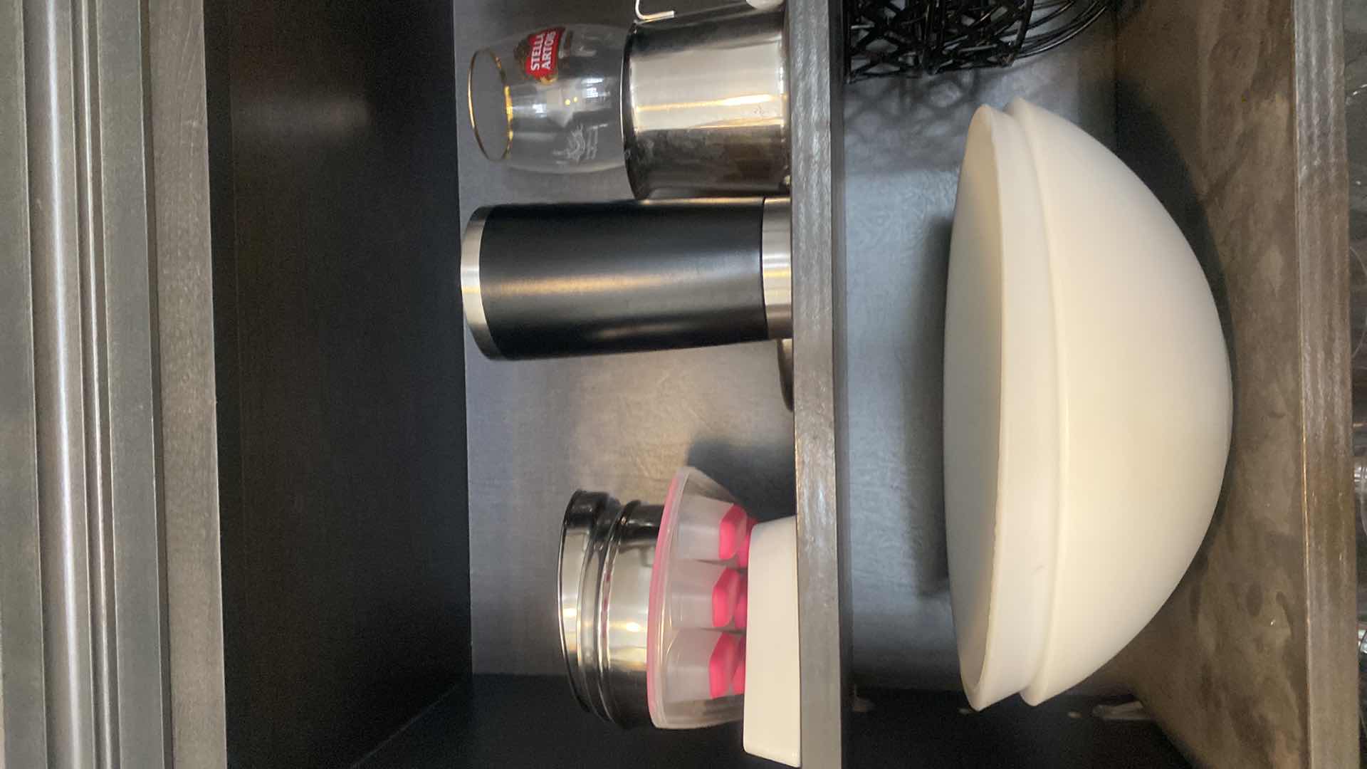 Photo 1 of CONTENTS KITCHEN CABINET-2 SHELVES BOWLS, 2 BLACK FRUIT BASKETS, TRAVEL CUPS