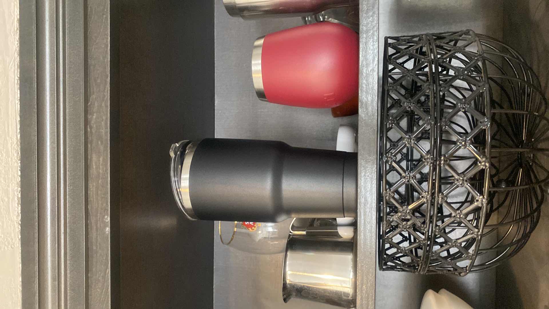 Photo 1 of CONTENTS KITCHEN CABINET-2 SHELVES BOWLS, 2 BLACK FRUIT BASKETS, TRAVEL CUPS