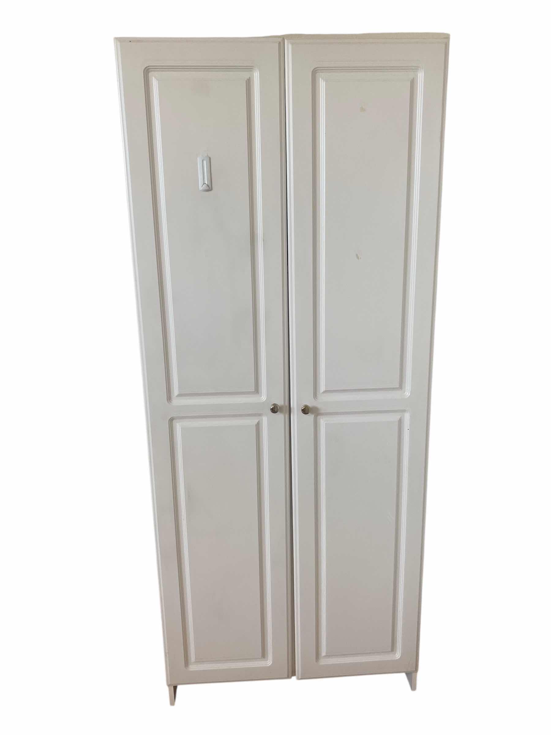 Photo 1 of WHITE TWO DOOR PRESSBOARD CABINET 30” x 15 1/2” H 72”