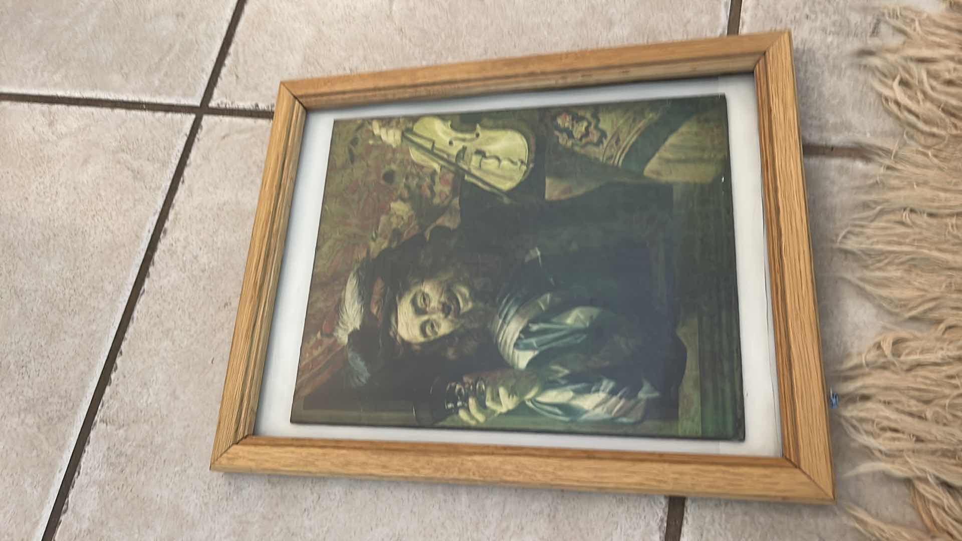 Photo 1 of VINTAGE FRAMED ARTWORK- The image shows a print of "The Merry Fiddler" by Gerard van Honthorst, painted in 1623. 11 1/2“ x H14 1/2“