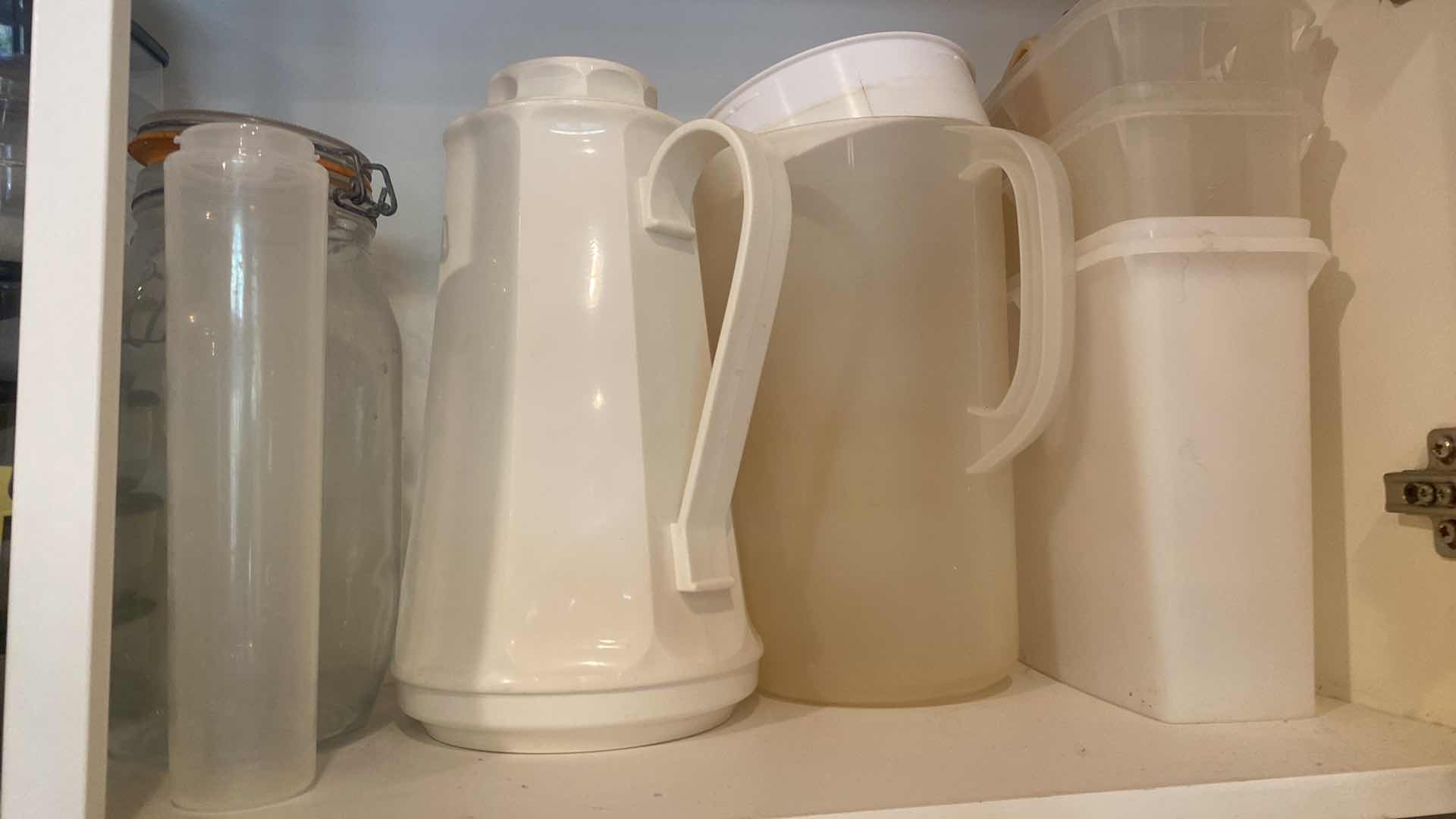 Photo 1 of CONTENTS OF KITCHEN CABINET - PLASTIC PITCHERS & STORAGE