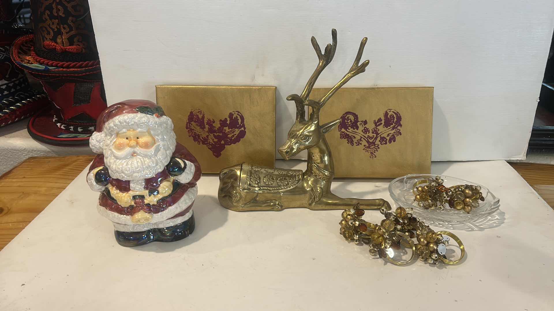 Photo 1 of CHRISTMAS DECOR /  LIDDED SANTA JAR, NAPKIN RINGS, BRASS REINDEER, ARTWORK & GLASS TRINKET DISH