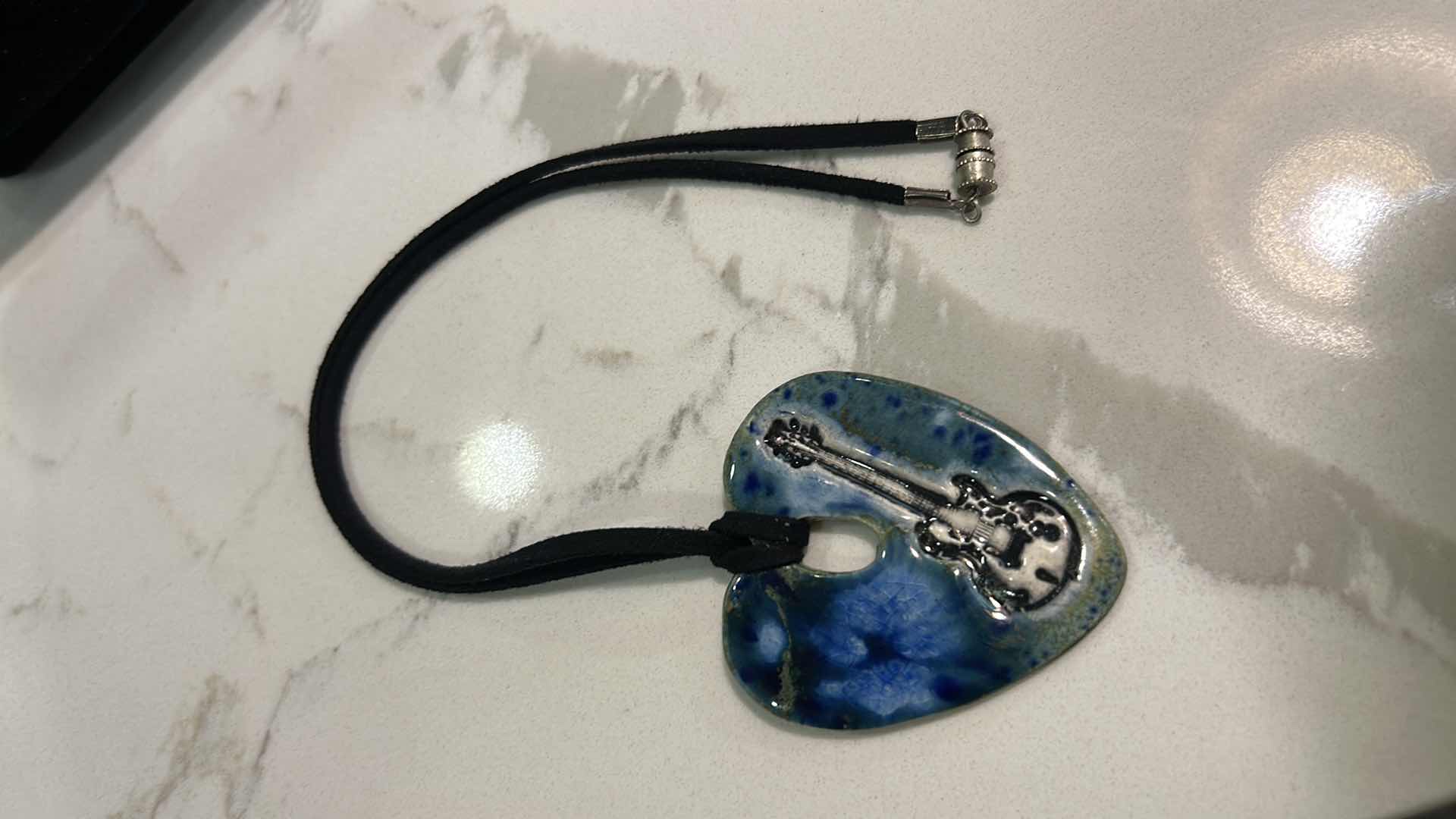 Photo 1 of MEN / WOMENS JEWELRY- FROM THE BRAND  SURLY-RAMICS,  HAND FORMED, HAND PAINTED BY ARTIST AMY DAVID ROTH,  CERAMIC HEART WITH GUITAR MADE FROM EARTHENWARE CLAY, FIRED TWICE AND FINISHED WITH LEAD FREE FOOD SAFE GLAZES. EACH PIECE IS UNIQUE