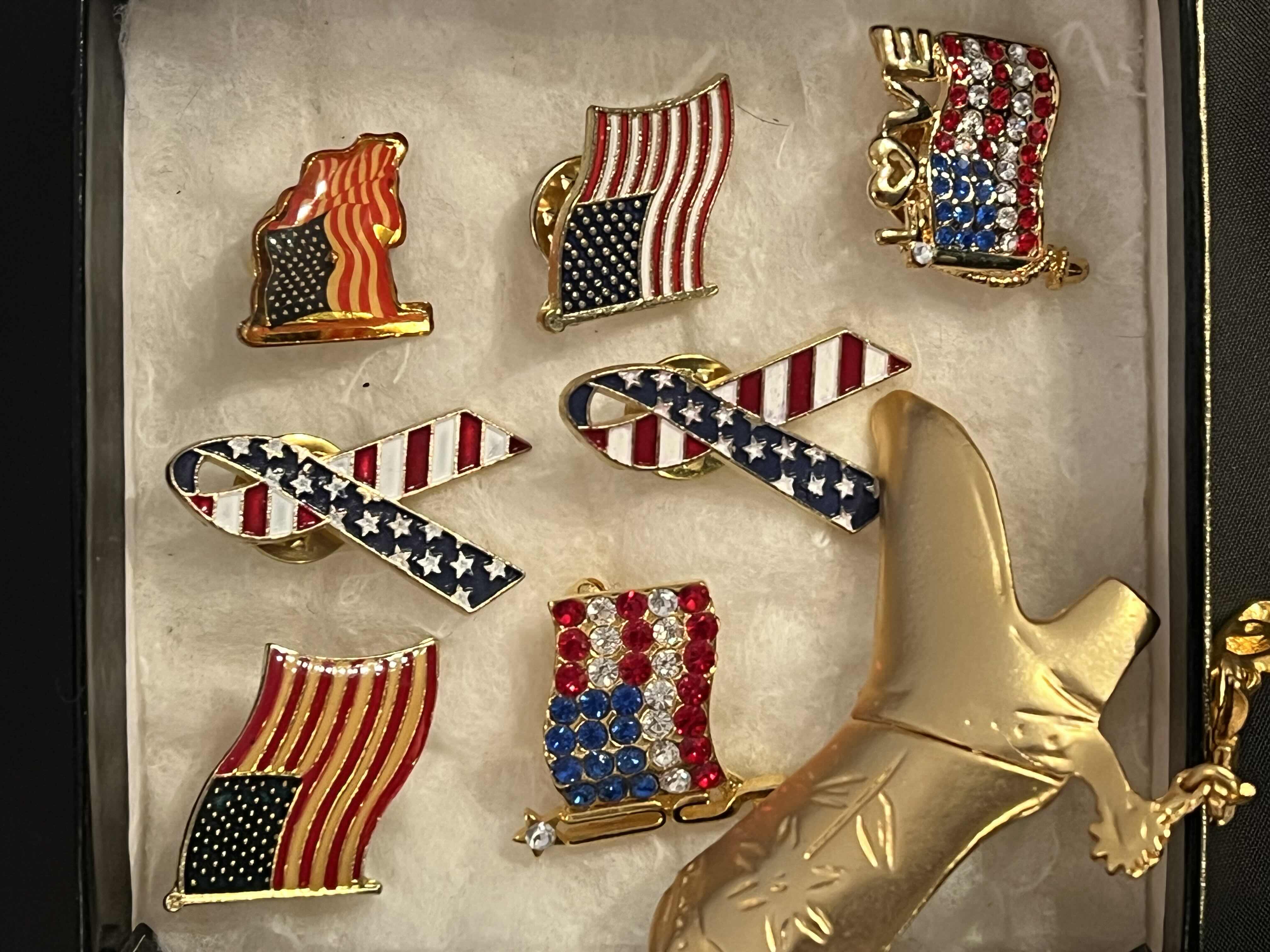 Photo 1 of AMERICAN FLAG PINS AND COWBOY BOOT BROACH.
