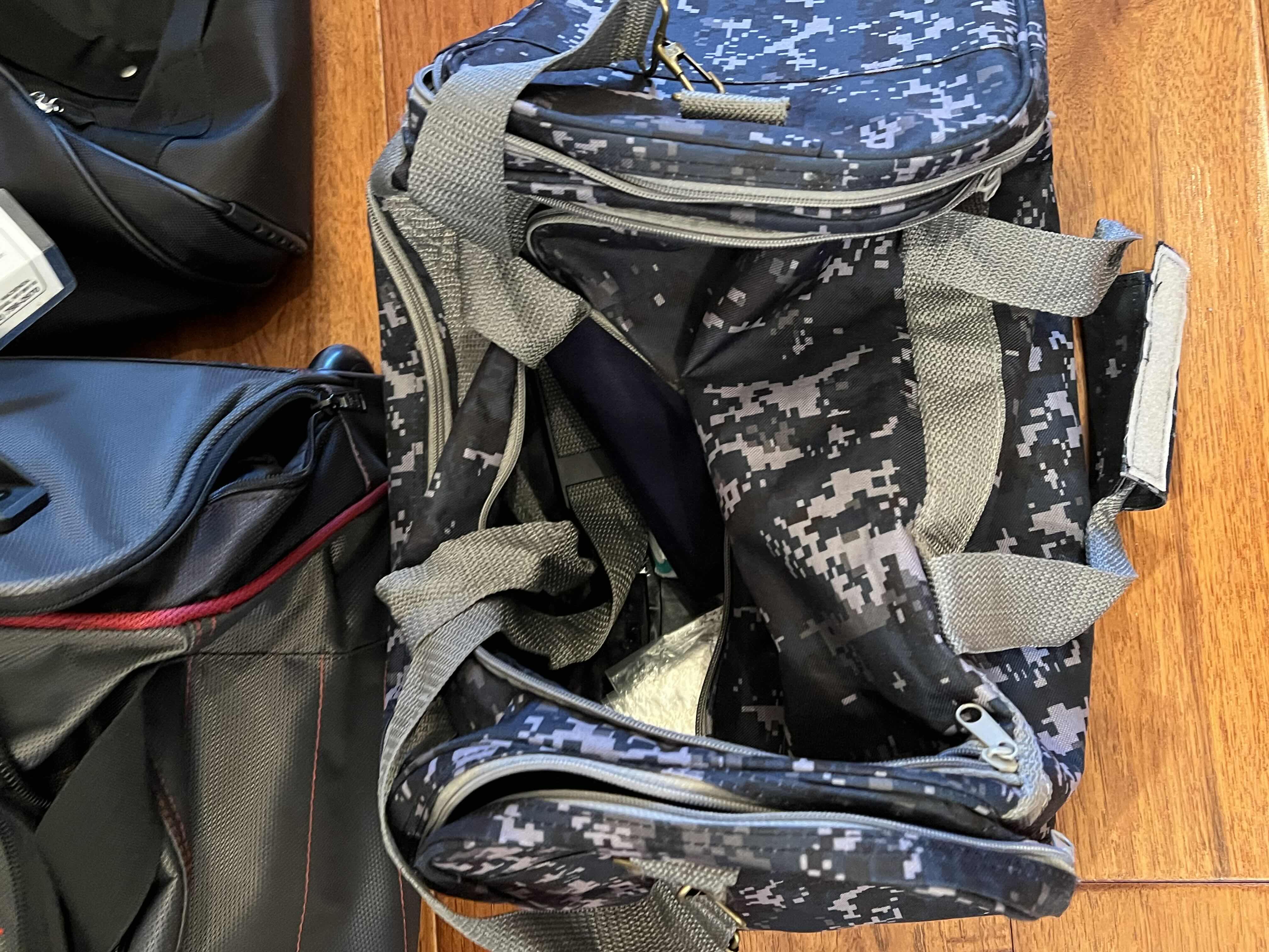 Photo 1 of 5-DUFFEL BAGS. VARIOUS STYLES ANS COLORS. ONE ROLLING BAG.