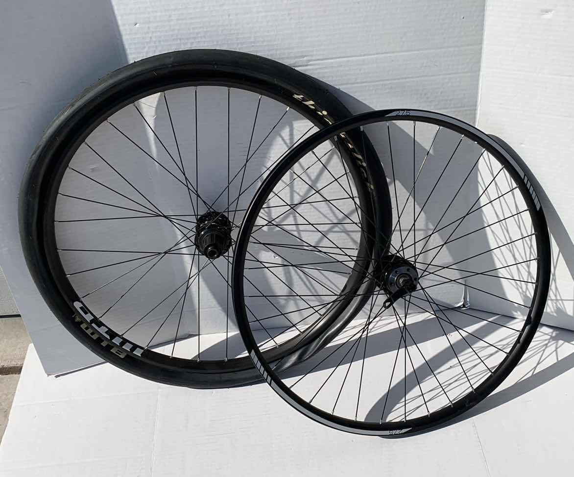 Photo 1 of 2-BICYCLE RIMS AND 1 TIRE. 27.5"D FOR A ROAD BIKE.