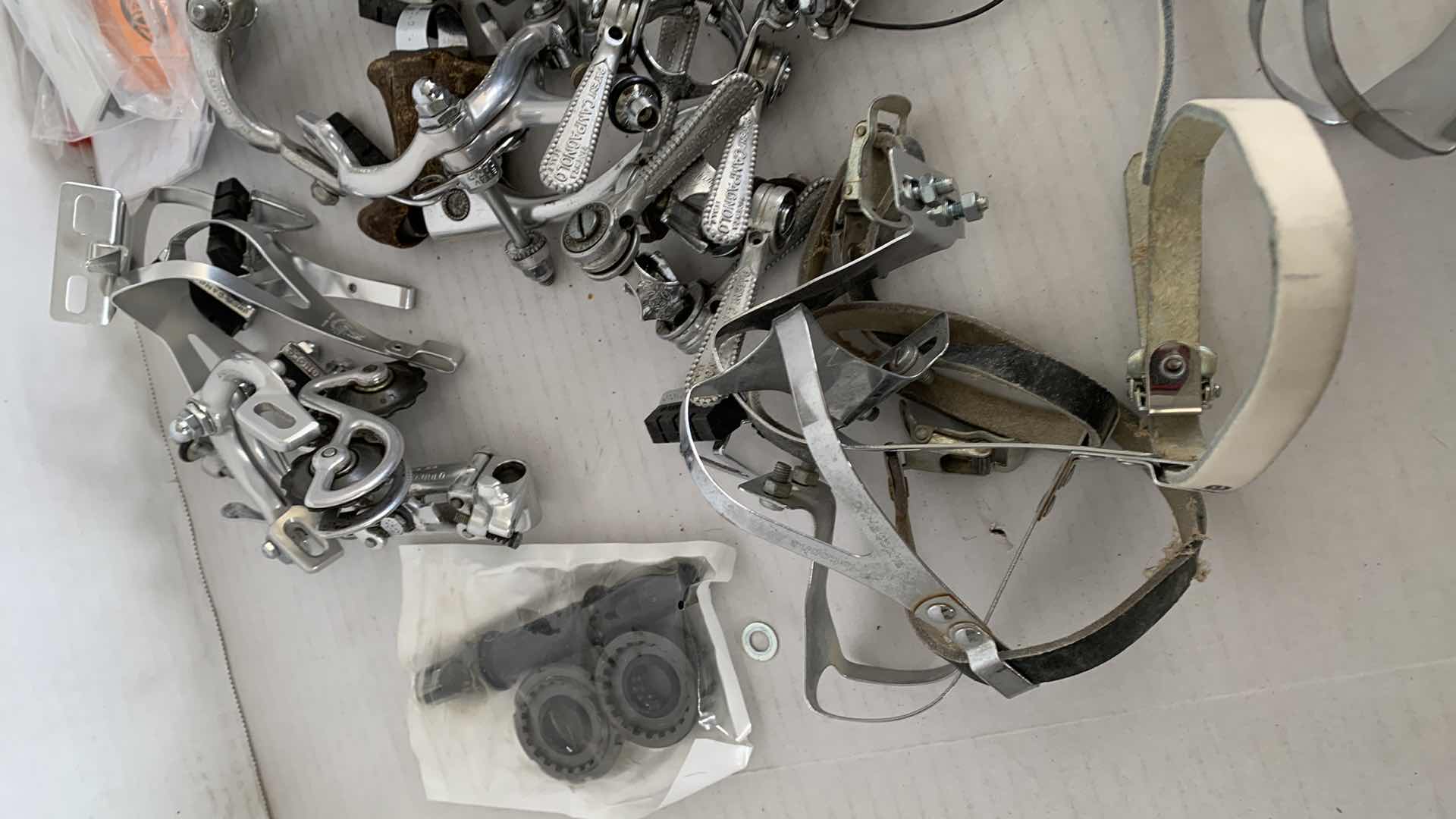 Photo 1 of BICYCLE BRAKES, FOOT STIRRUPS, AND OTHER ITEMS. ROAD BICYCLE ACCESSORIES.