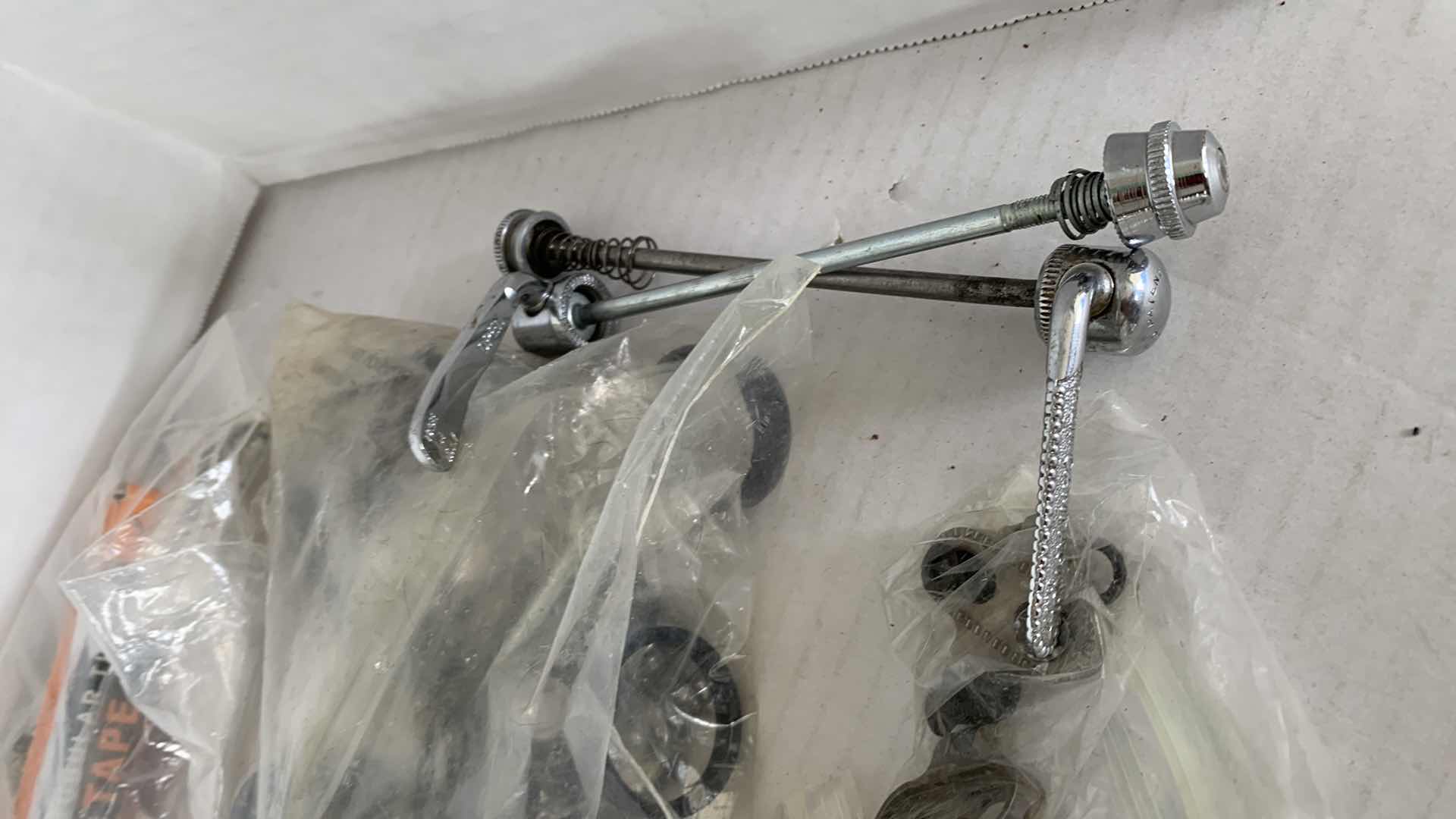 Photo 1 of BICYCLE BRAKES, FOOT STIRRUPS, AND OTHER ITEMS. ROAD BICYCLE ACCESSORIES.