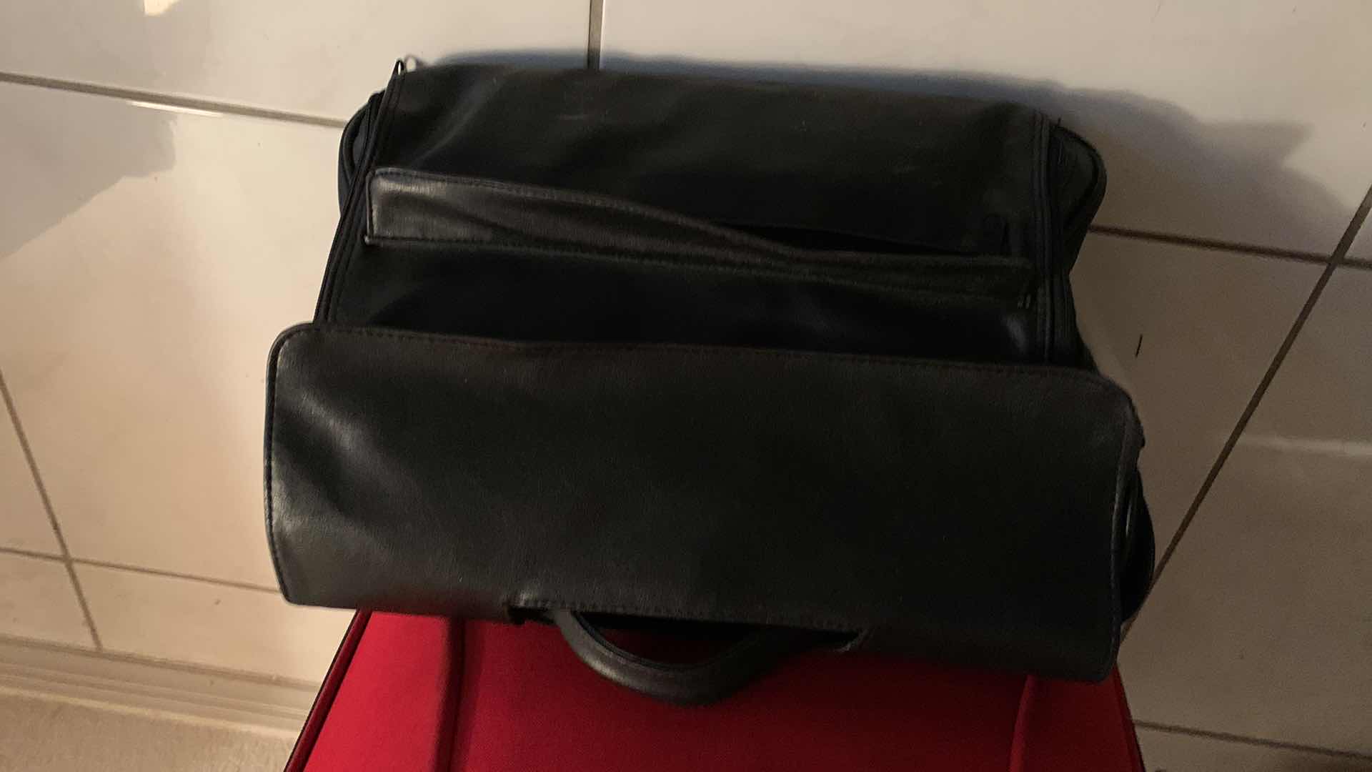 Photo 3 of CARRY ON ROLLER LUGGAGE, AND A LEATHER DOCUMENT TOTE BAG.