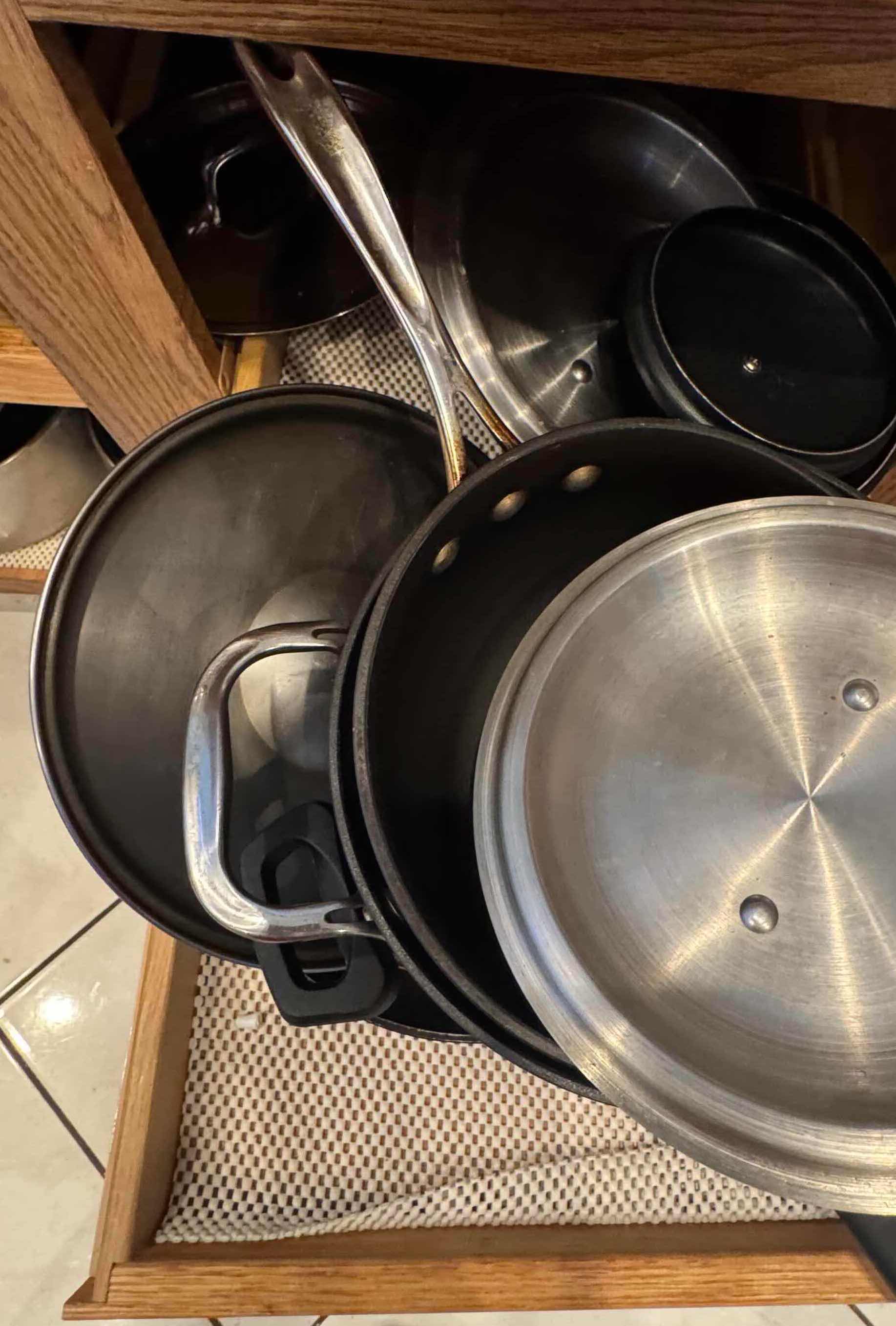 Photo 1 of CONTENTS OF KITCHEN CABINET. POTS AND PANS VARIOUS SIZES.