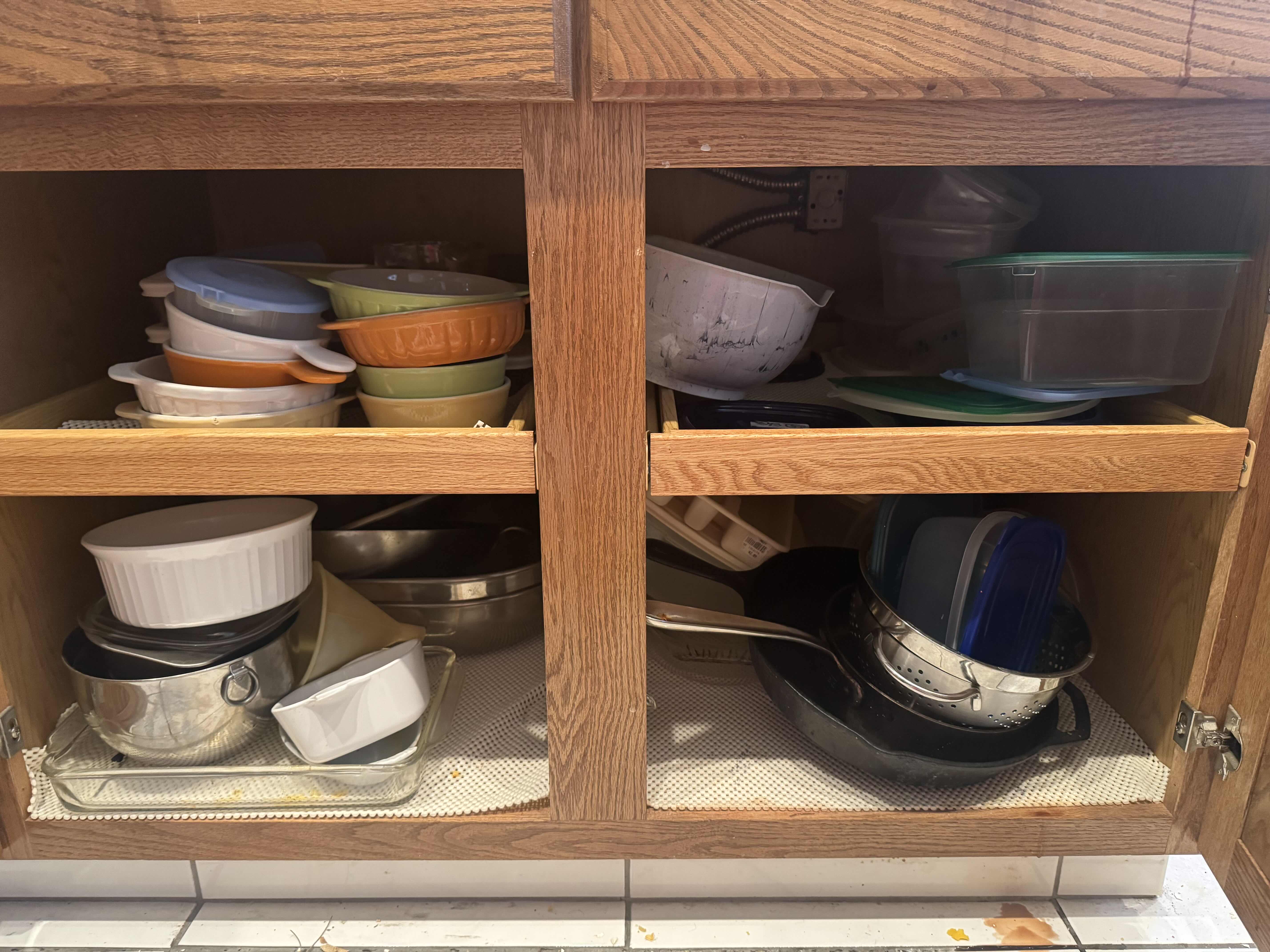Photo 1 of CONTENTS OF KITCHEN CABINET. MIXING AND SERVING BOWLS AND DISHES. POTS AND PANS, AND BAKING DISHES.