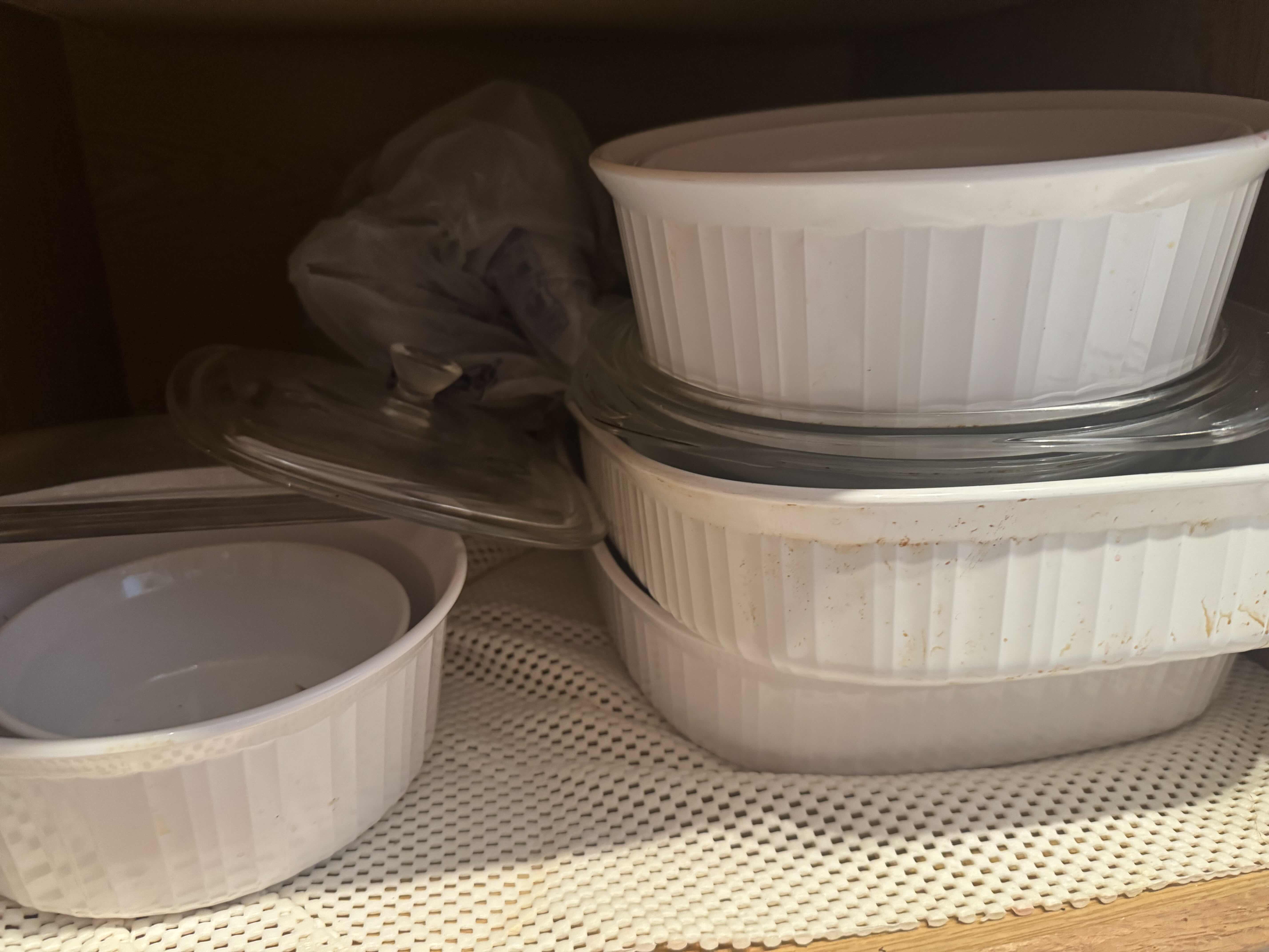 Photo 1 of CONTENTS OF KITCHEN CABINET CABINET. BAKING, SERVING AND CASSEROLE DISHES.