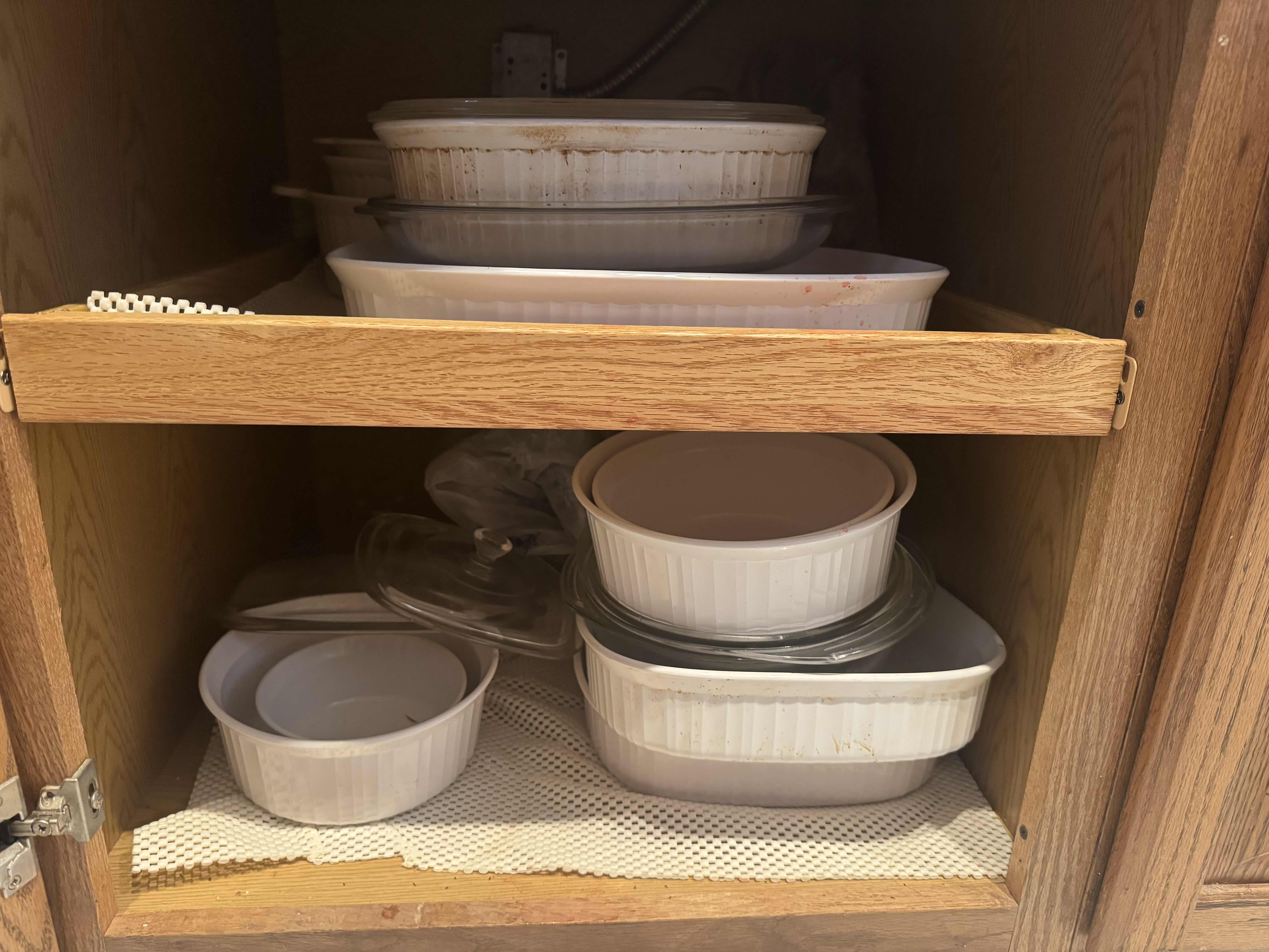 Photo 1 of CONTENTS OF KITCHEN CABINET CABINET. BAKING, SERVING AND CASSEROLE DISHES.