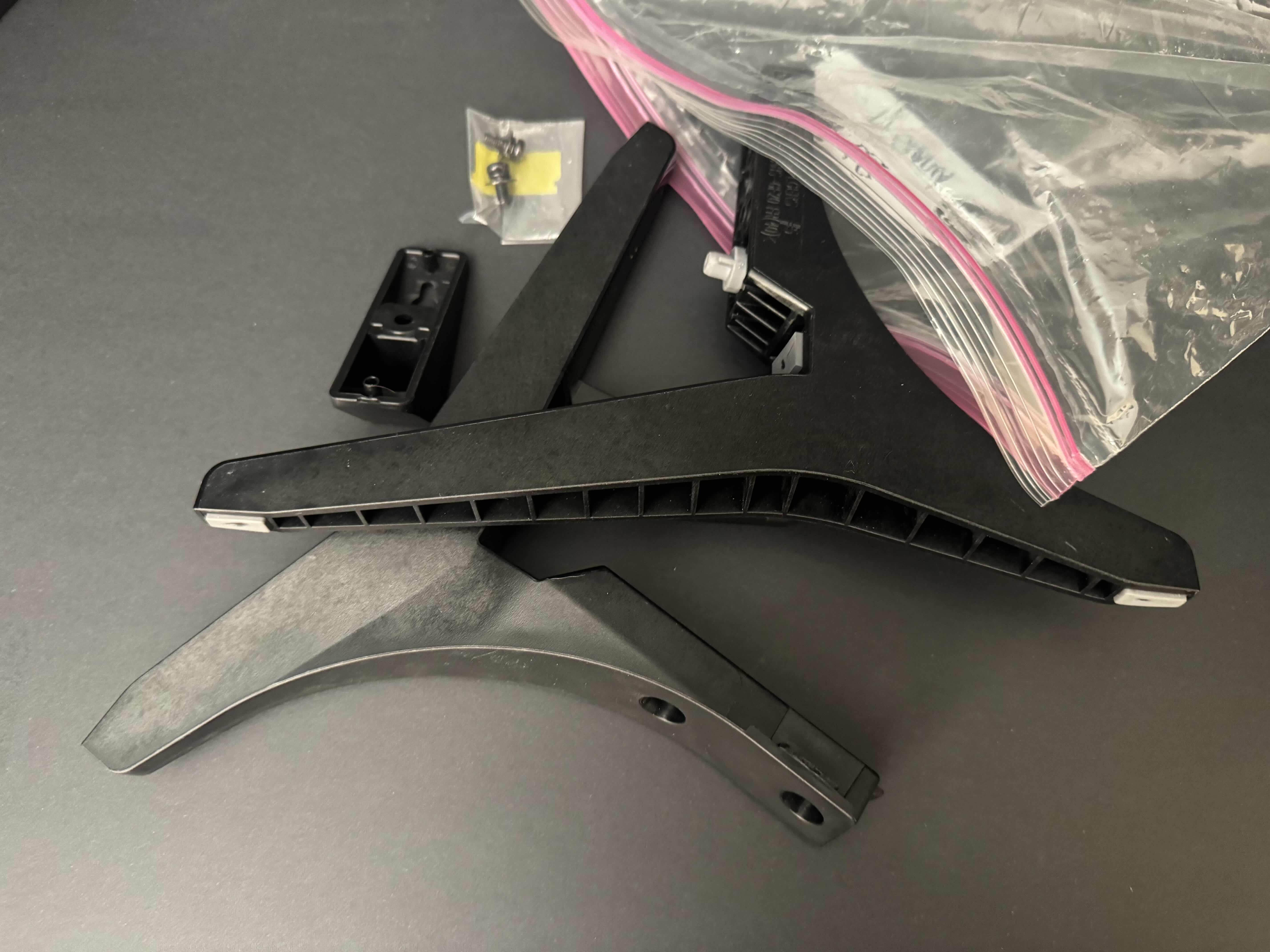 Photo 1 of BLACK WOVEN BASKET FILLED WITH ELECTRONIC CORDS AND LARGE TV LEGS, 2 PORTABLE PHONE CHARGERS & AMAZON TV HUB