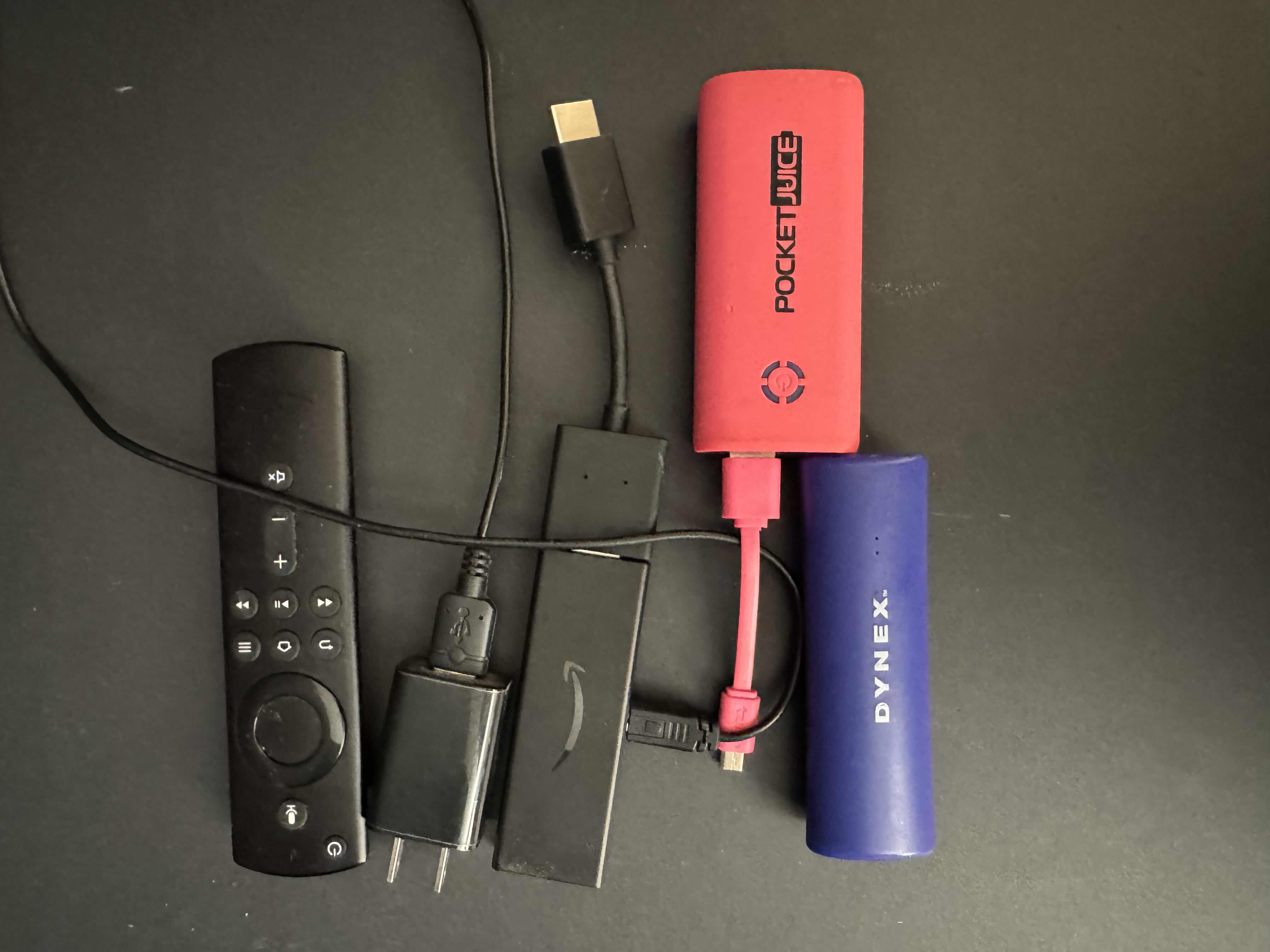 Photo 4 of BLACK WOVEN BASKET FILLED WITH ELECTRONIC CORDS AND LARGE TV LEGS, 2 PORTABLE PHONE CHARGERS & AMAZON TV HUB