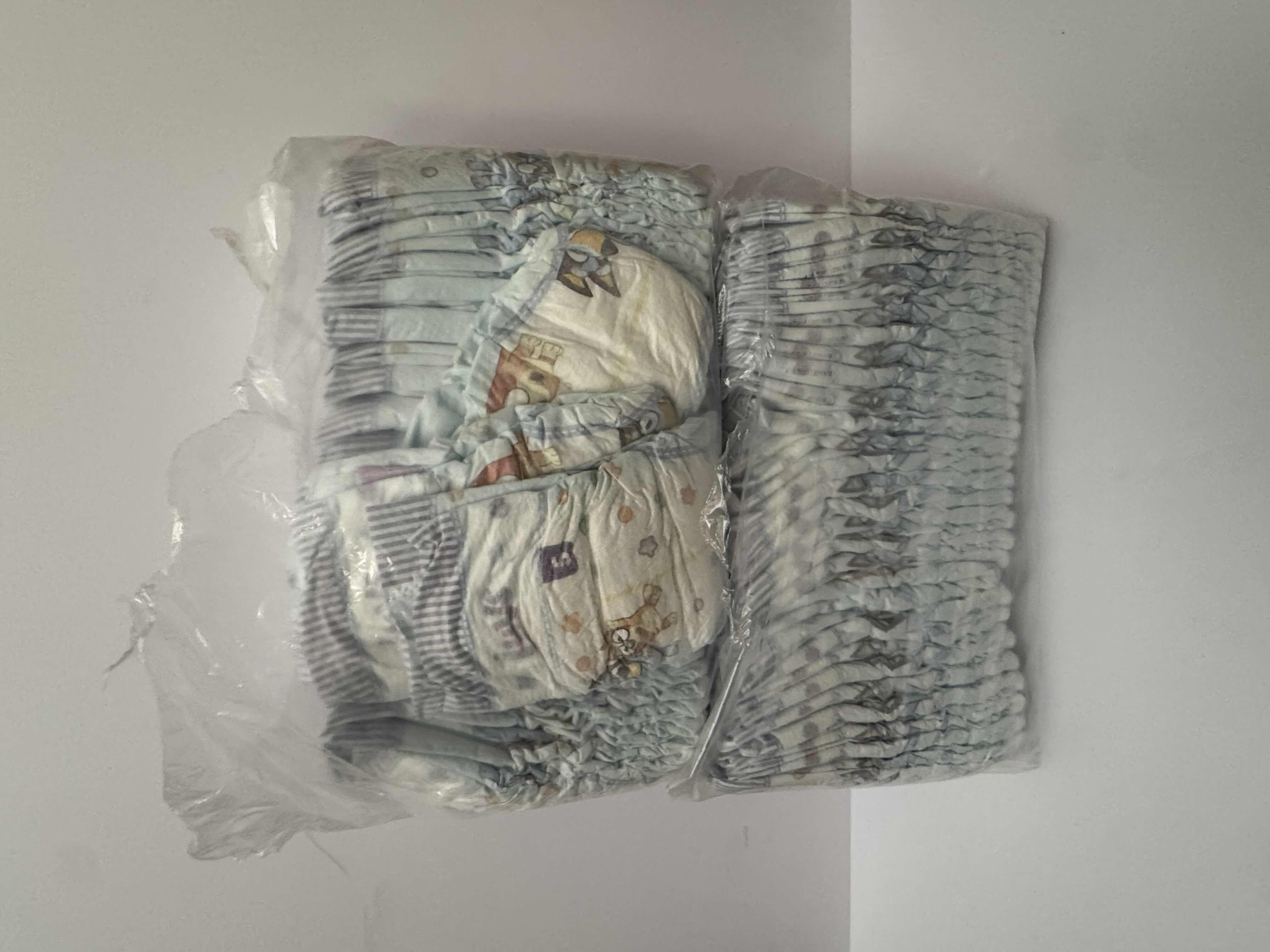 Photo 1 of 2 OPEN PACKAGES OF LUVS SIZE 5 DIAPERS