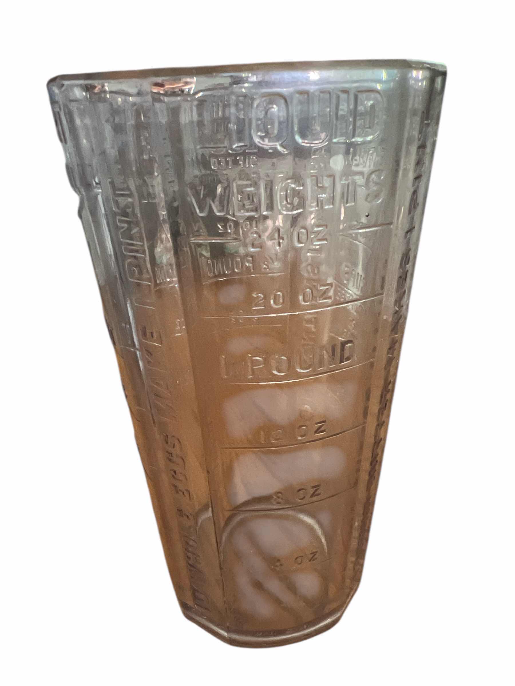 Photo 1 of “SILVER AND CO” GLASS MEASURING JAR - 7 1/2” AND PINK DEPRESSION GLASS JUICE GLASS