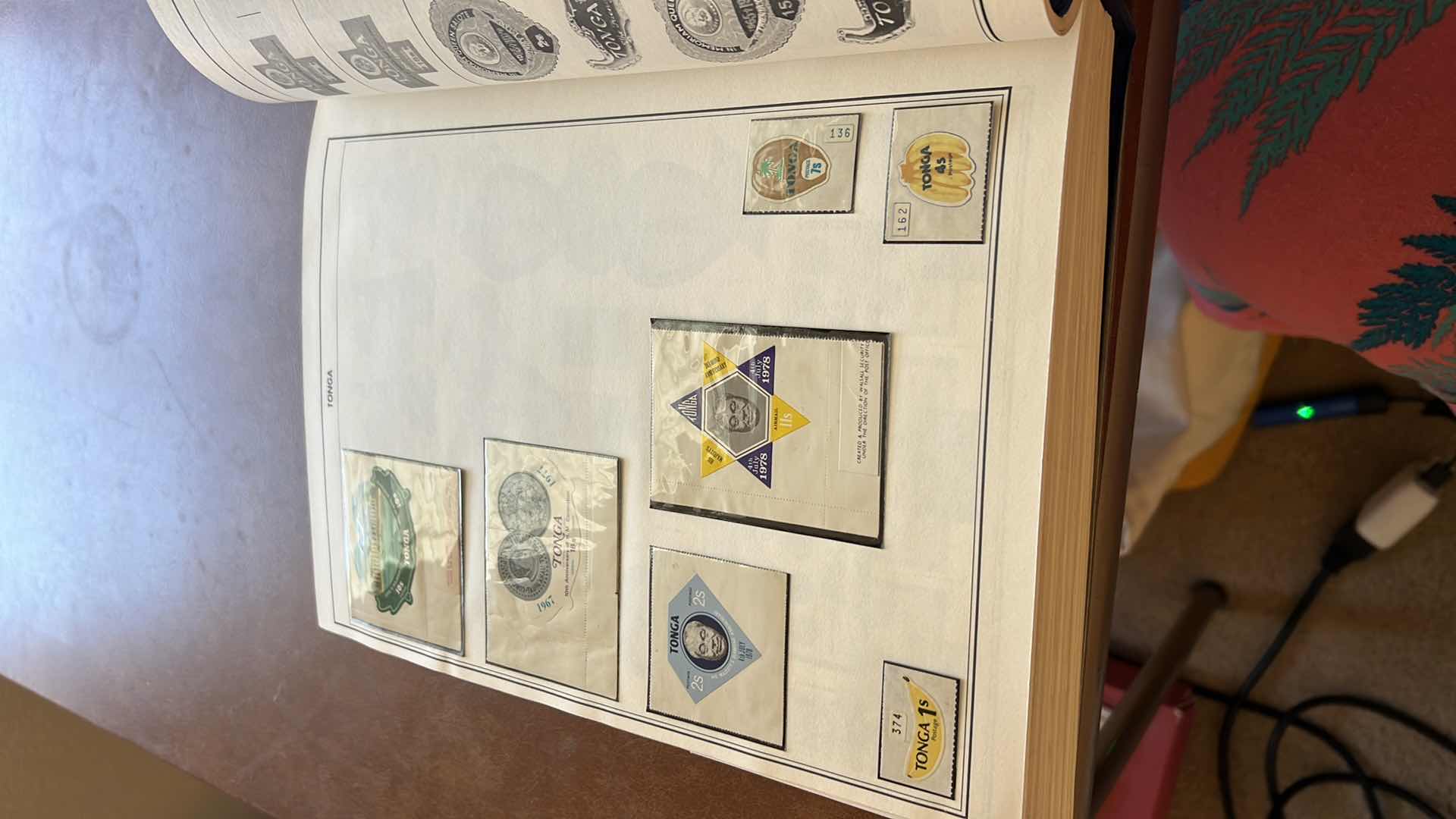 Photo 5 of “POSTAGE STAMPS OF THE UNITED STATES” ALBUM (NO CONTENT) AND “AMBASSADOR’S FOR STAMPS OF THE WORLD” SEVERAL PAGES OF MINT AND CANCELLED FOREIGN STAMPS STAMPS - NO RETURNS