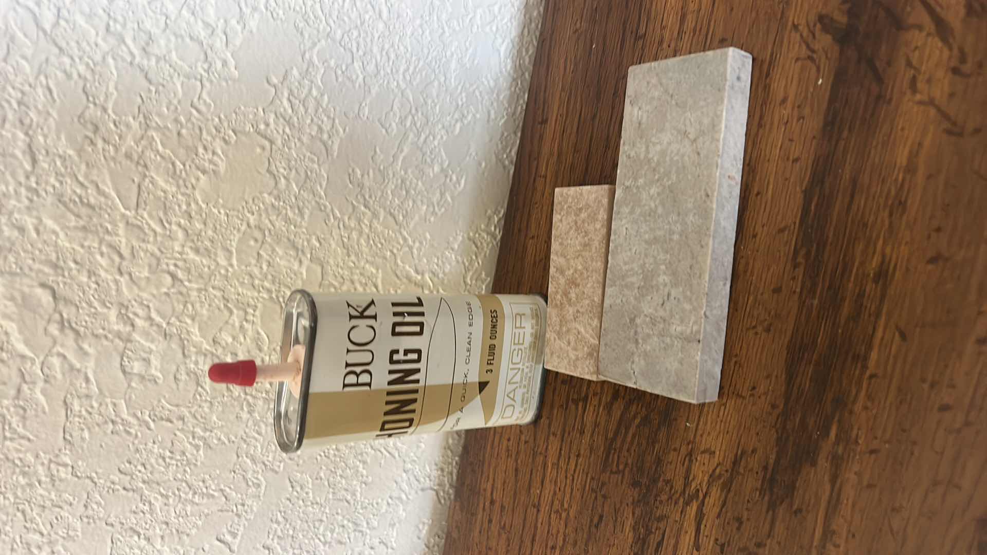 Photo 1 of VINTAGE COLLECTIBLES - BUCK KNIFE WITH LEATHER SHEATH, HONING TOOLS AND BOOKENDS