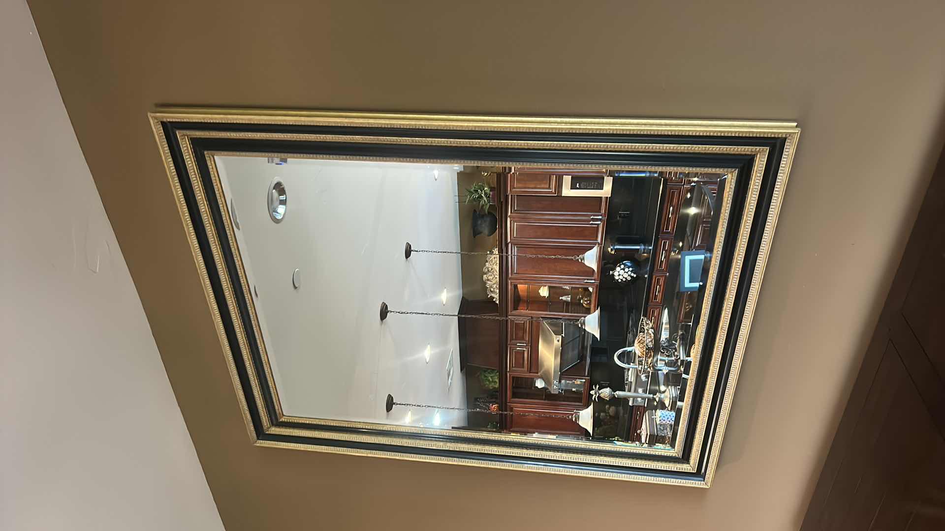 Photo 1 of VERY LARGE ORNATELY FRAMED IN GOLD AND BLACK BEVELED GLASS MIRROR 
57 inches five 44 1/2 inches