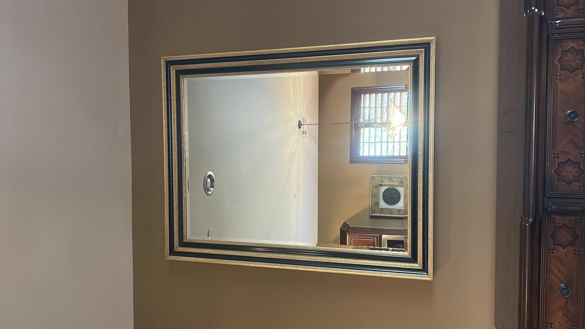 Photo 1 of VERY LARGE ORNATELY FRAMED IN GOLD AND BLACK BEVELED GLASS MIRROR 
57 inches five 44 1/2 inches