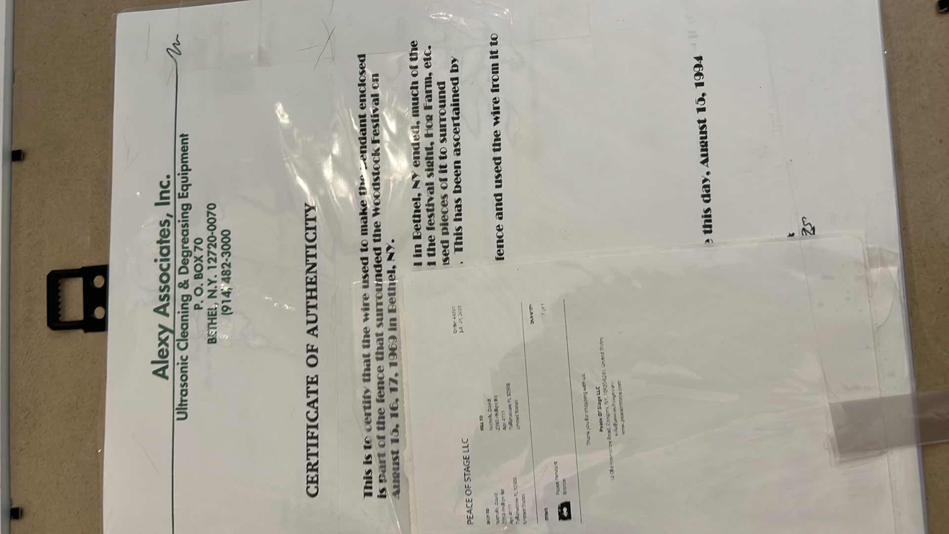 Photo 1 of AUTHENTIC WOODSTOCK FESTIVAL 1969 MEMORABILIA IN ORIGINAL DESIGNED SHADOW BOX. 12“ x 15“INCLUDES WOODSTOCK TICKET, PIECE OF THE GATE AND PIECE OF THE STAGE. GATE AND STAGE CRAFTED INTO PEACE SIGNS. DOCUMENTATION AND AUTHENTICITY PAPERS INCLUDED.