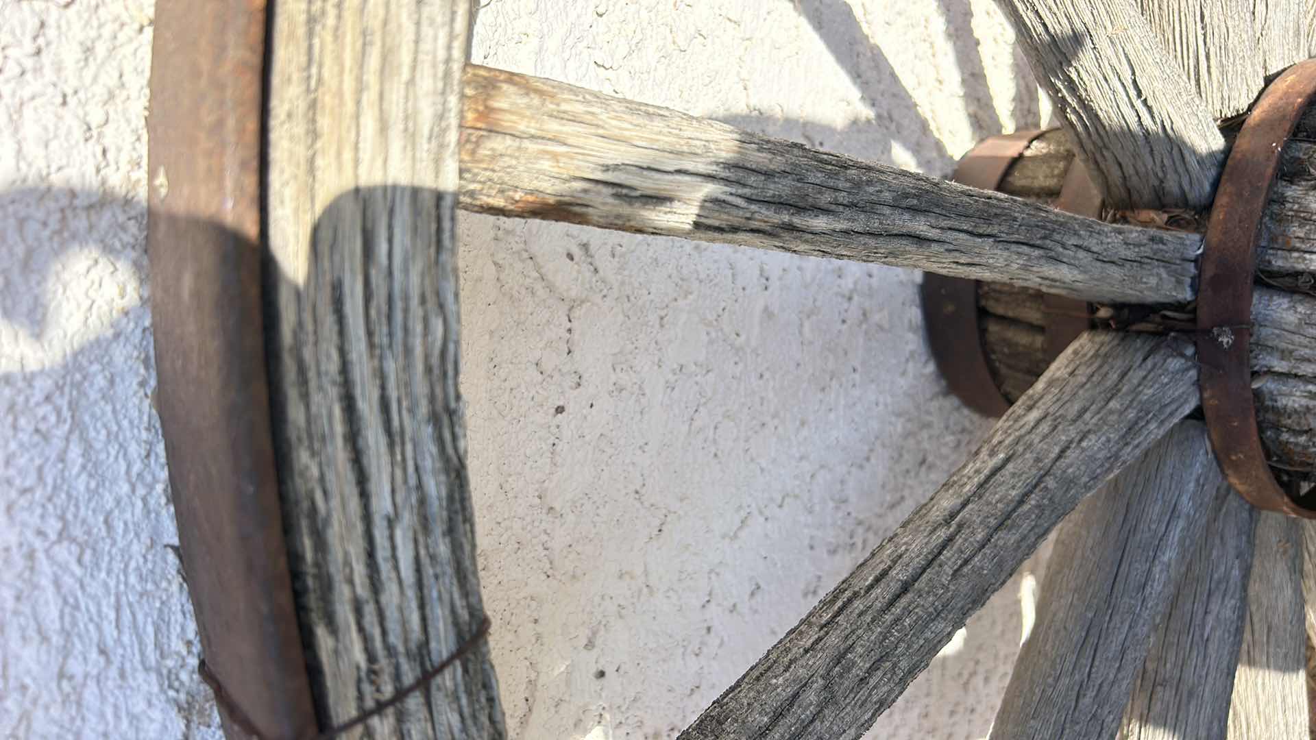 Photo 1 of ANTIQUE WOOD AND FORGED BRONZE WAGON WHEEL 42”