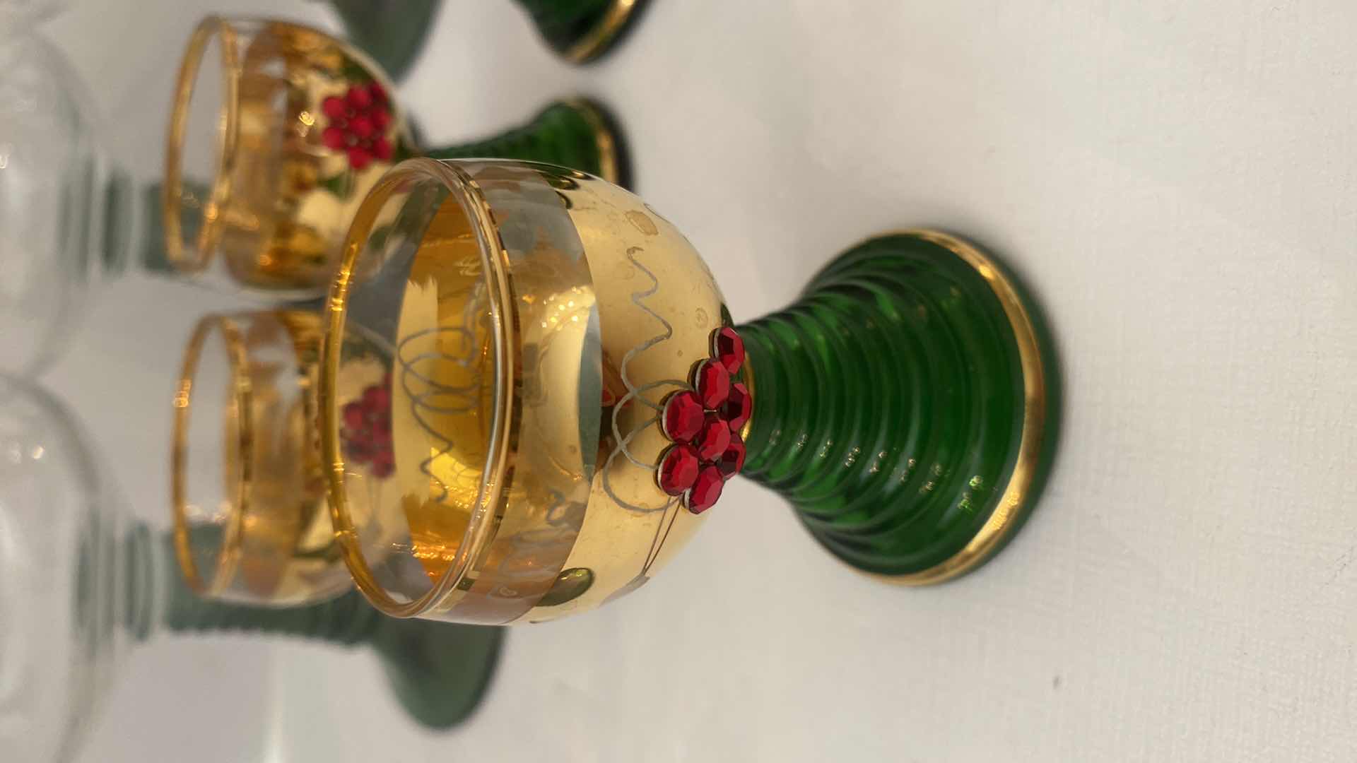 Photo 1 of VINTAGE GERMAN ROEMER GREEN AND GOLD RIMMED WINE GLASSES AND GOLD JEWELED SHOT GLASSES