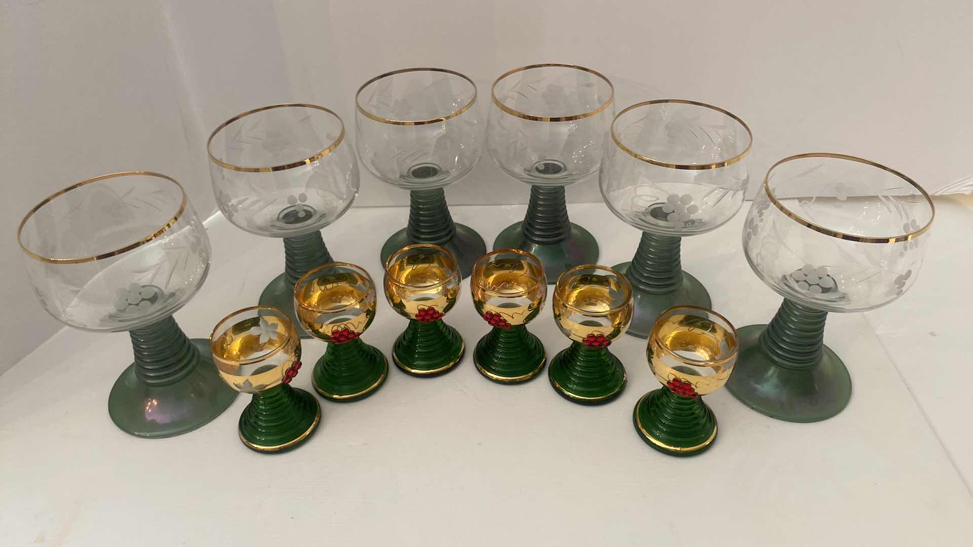 Photo 1 of VINTAGE GERMAN ROEMER GREEN AND GOLD RIMMED WINE GLASSES AND GOLD JEWELED SHOT GLASSES