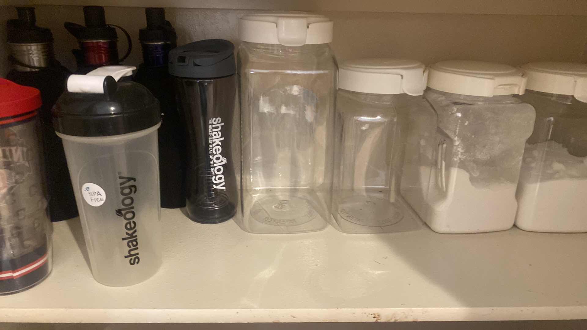 Photo 1 of 2 - BOTTOM SHELFS PANTRY - STORAGE PLASTICS & CUPS