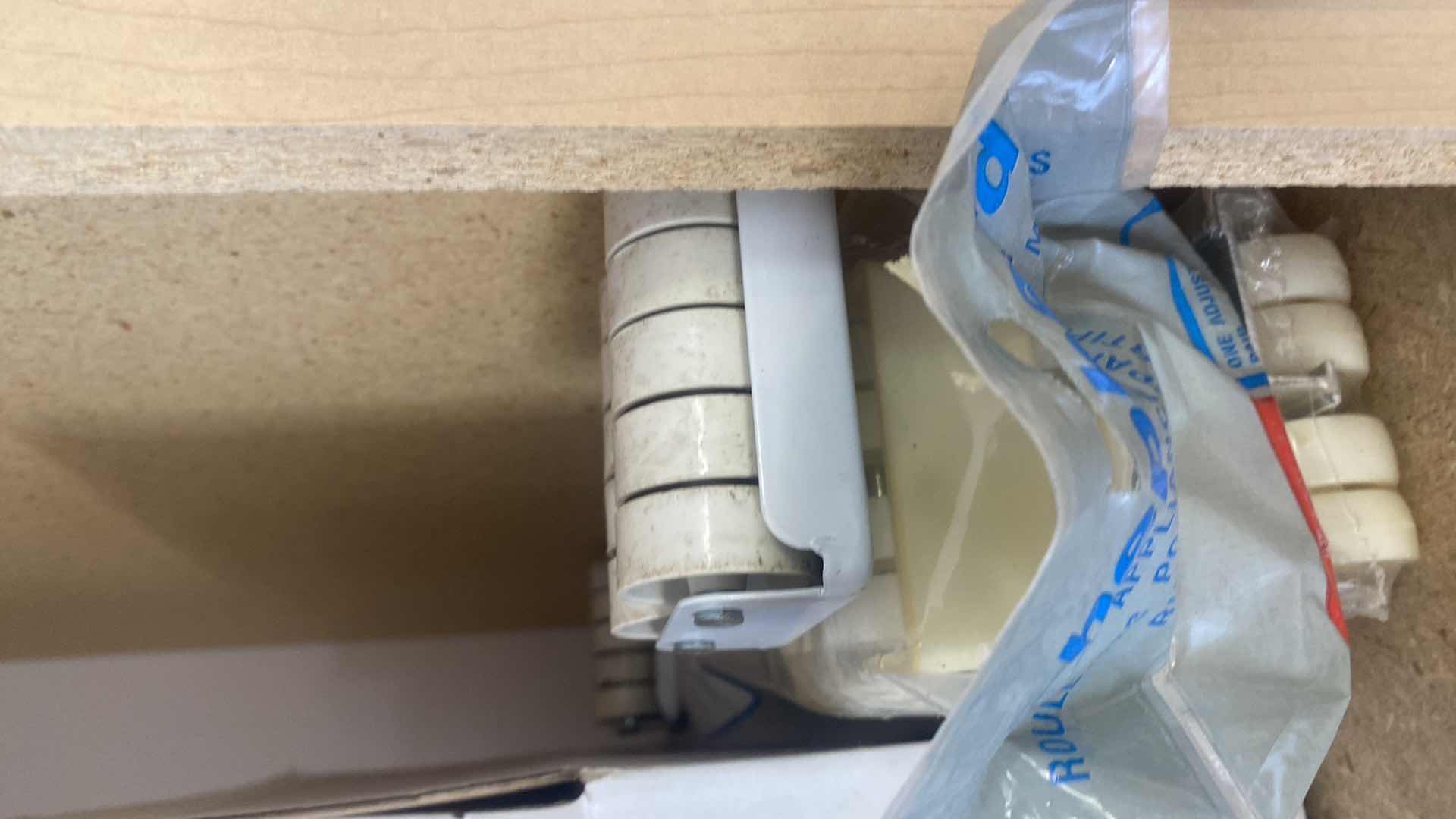 Photo 1 of CONTENTS OF CABINET - 6 LIGHT BULBS & NEW RUG PAD 6’ x 9’ & APPLIANCE ROLLERS