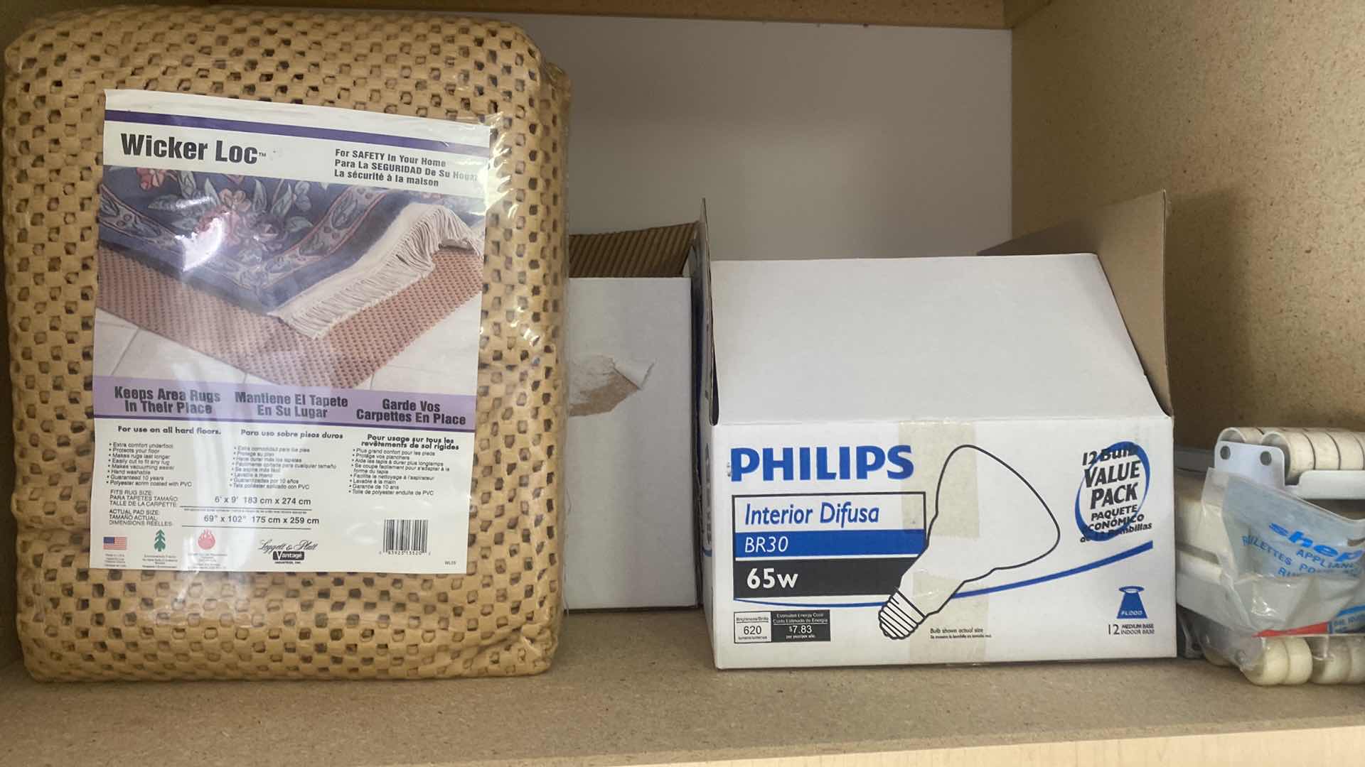 Photo 1 of CONTENTS OF CABINET - 6 LIGHT BULBS & NEW RUG PAD 6’ x 9’ & APPLIANCE ROLLERS