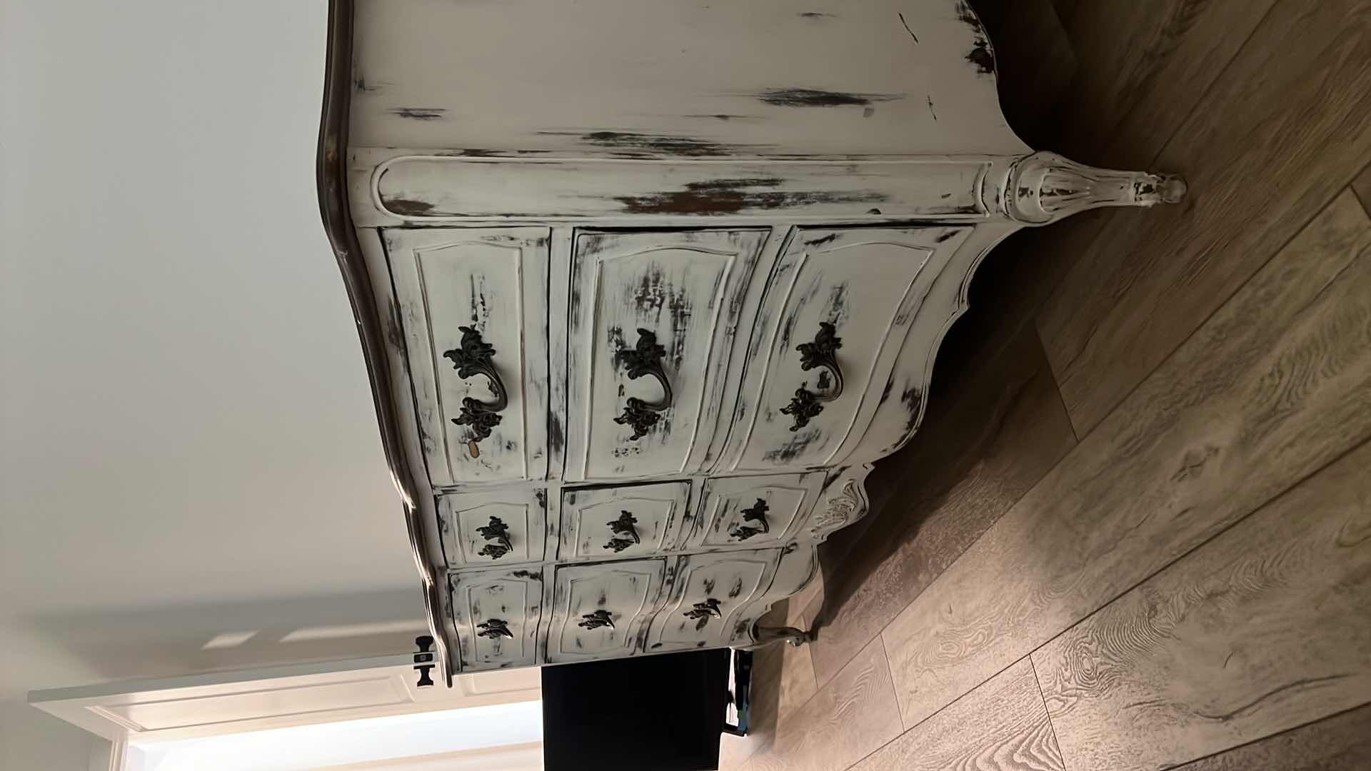 Photo 1 of FURNITURE-WHITE DISTRESSED WOOD DRESSER WITH 9 DRAWERS. 58“ x 20“ x 29“.