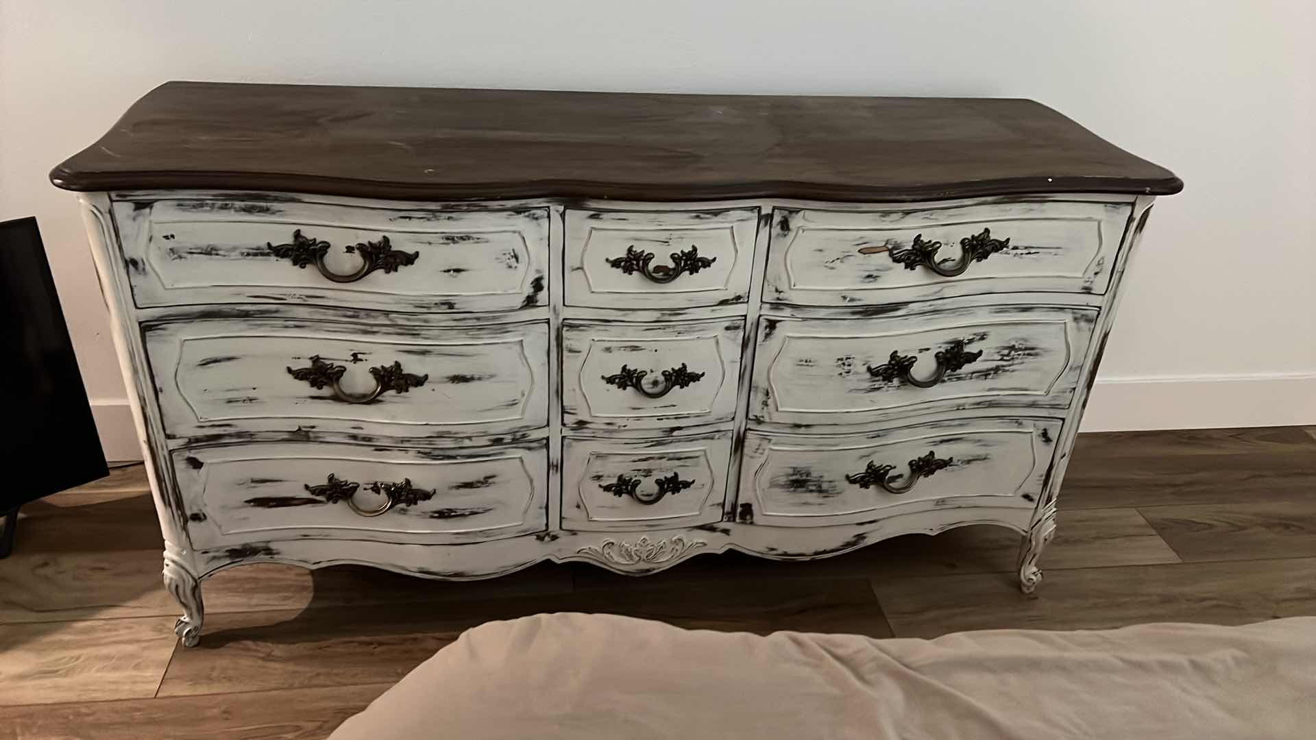 Photo 1 of FURNITURE-WHITE DISTRESSED WOOD DRESSER WITH 9 DRAWERS. 58“ x 20“ x 29“.