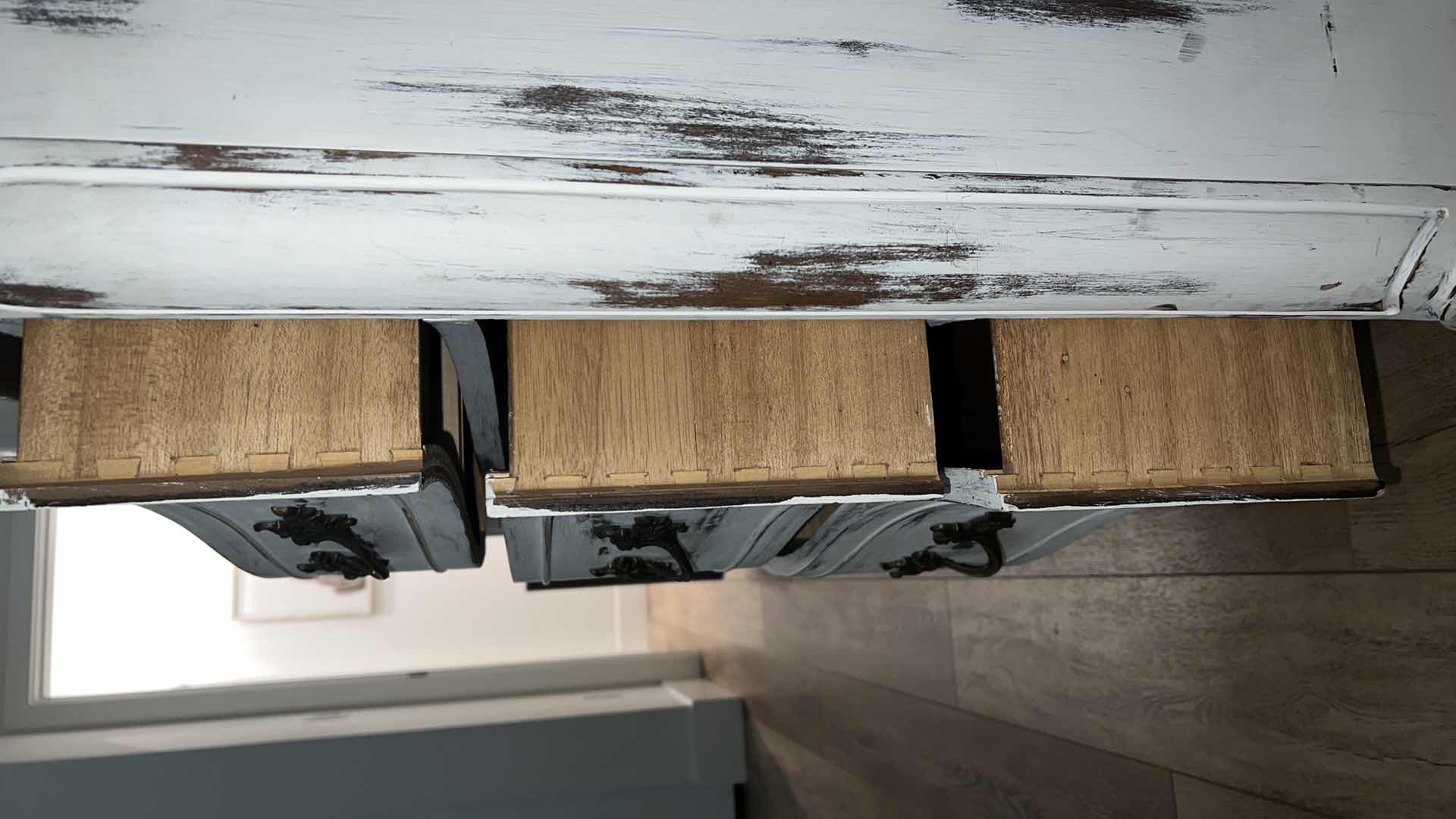 Photo 1 of FURNITURE-WHITE DISTRESSED WOOD DRESSER WITH 9 DRAWERS. 58“ x 20“ x 29“.