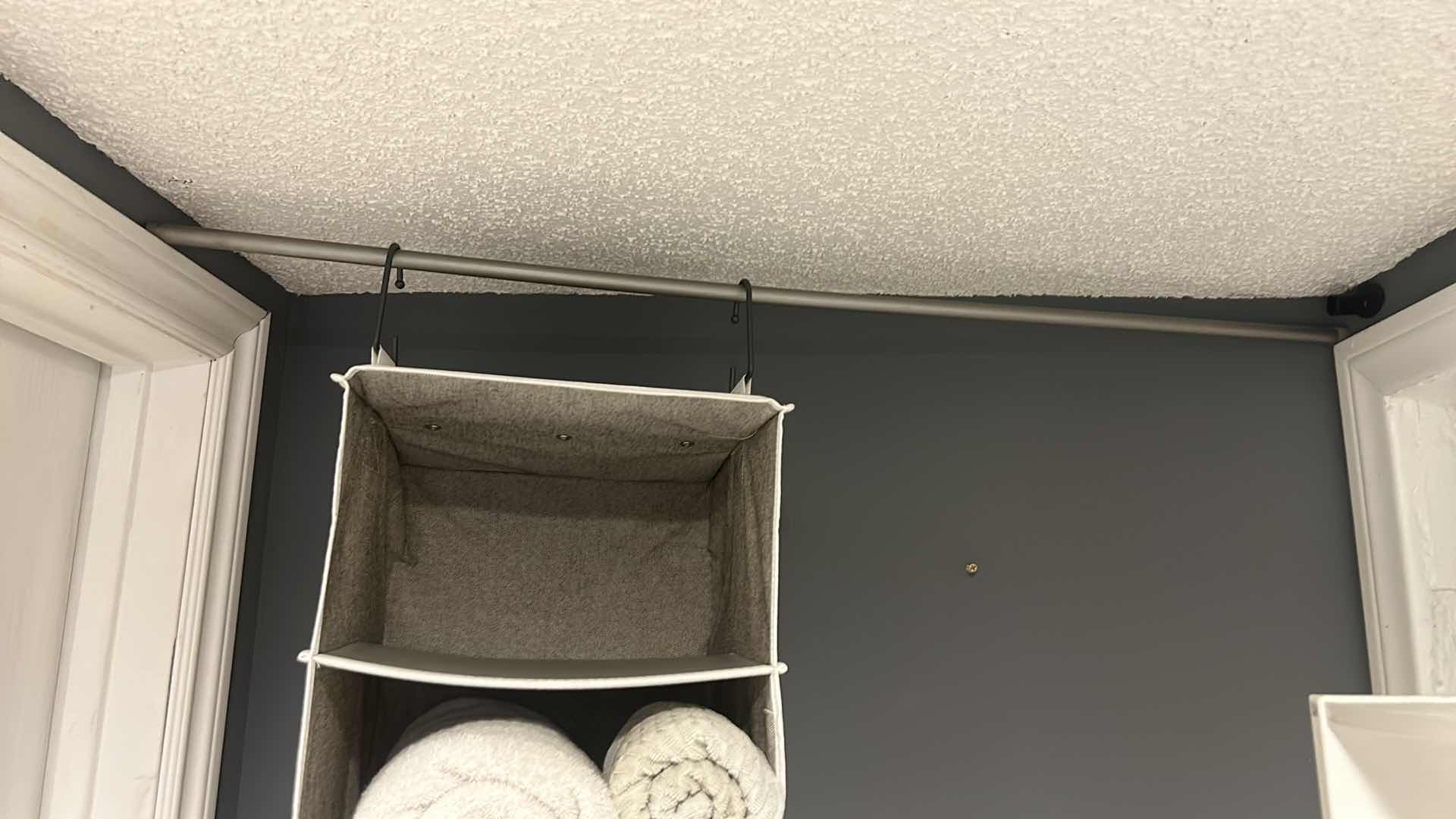 Photo 1 of HANGING STORAGE BASKET WITH POLE AND TOWELS