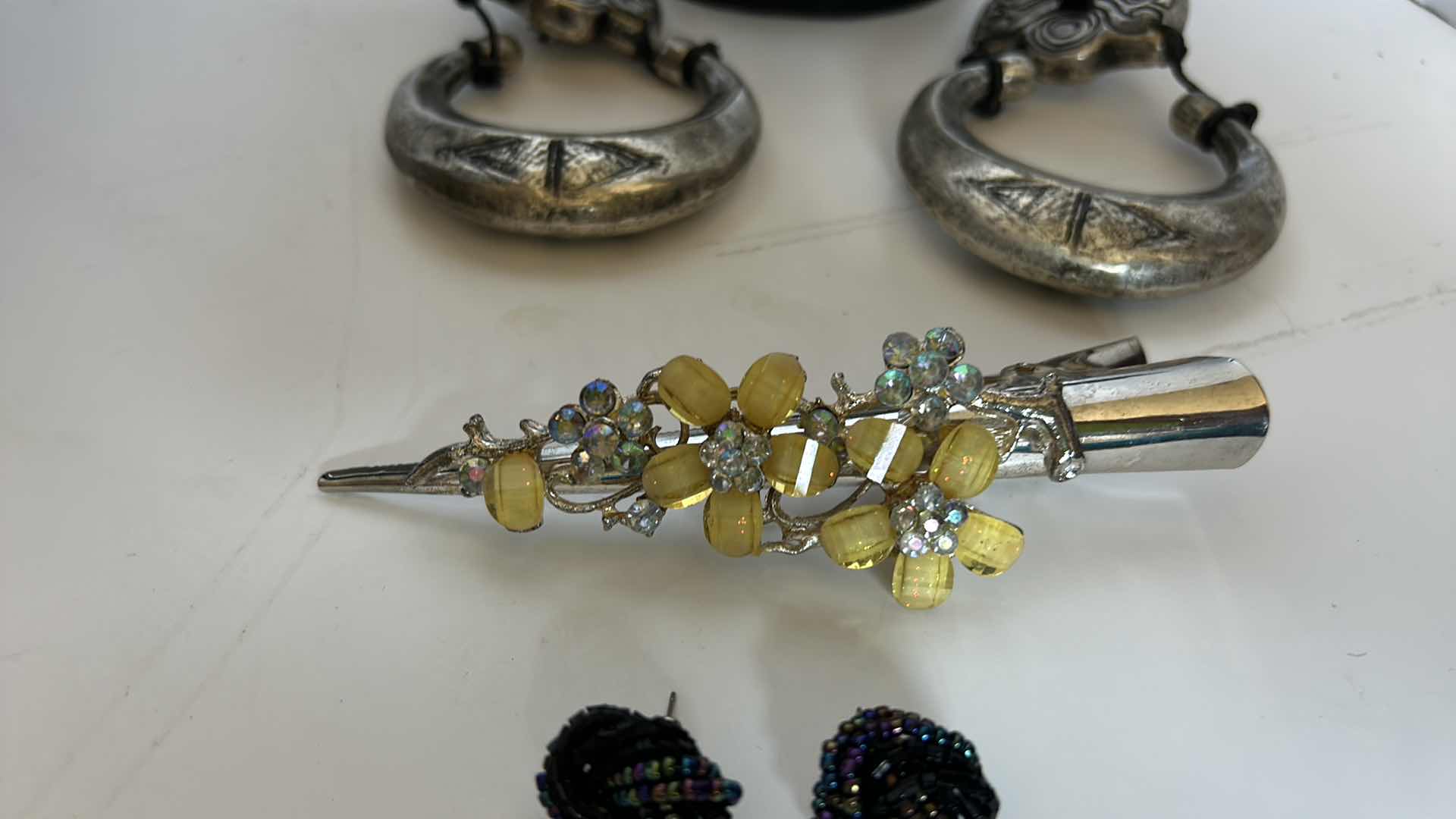 Photo 1 of COSTUME JEWELRY, ONE NECKLACE, TWO PAIRS OF EARRINGS, AND A BARRETTE.