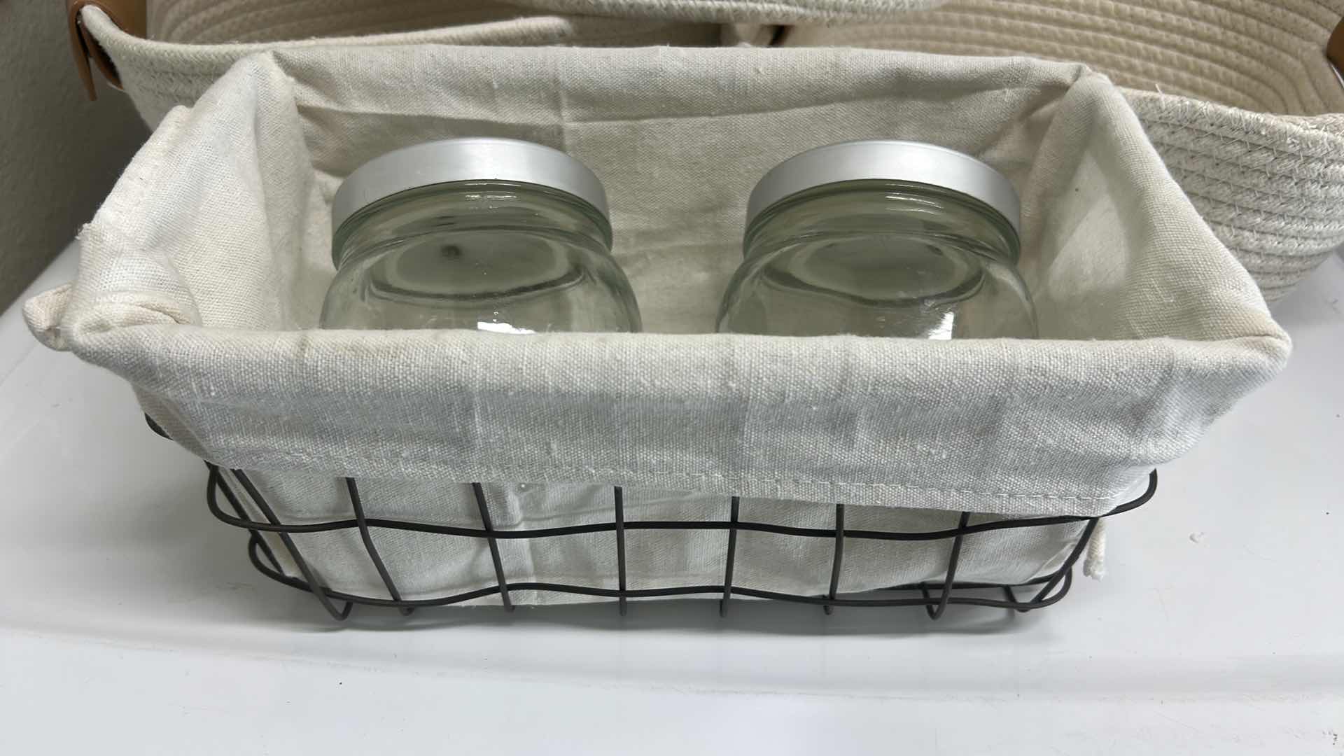 Photo 1 of 3 WOVEN BASKETS 10 1/2” x 10 1/2” x 5” AND 1 METAL BASKET WITH 2 LIDDED JARS