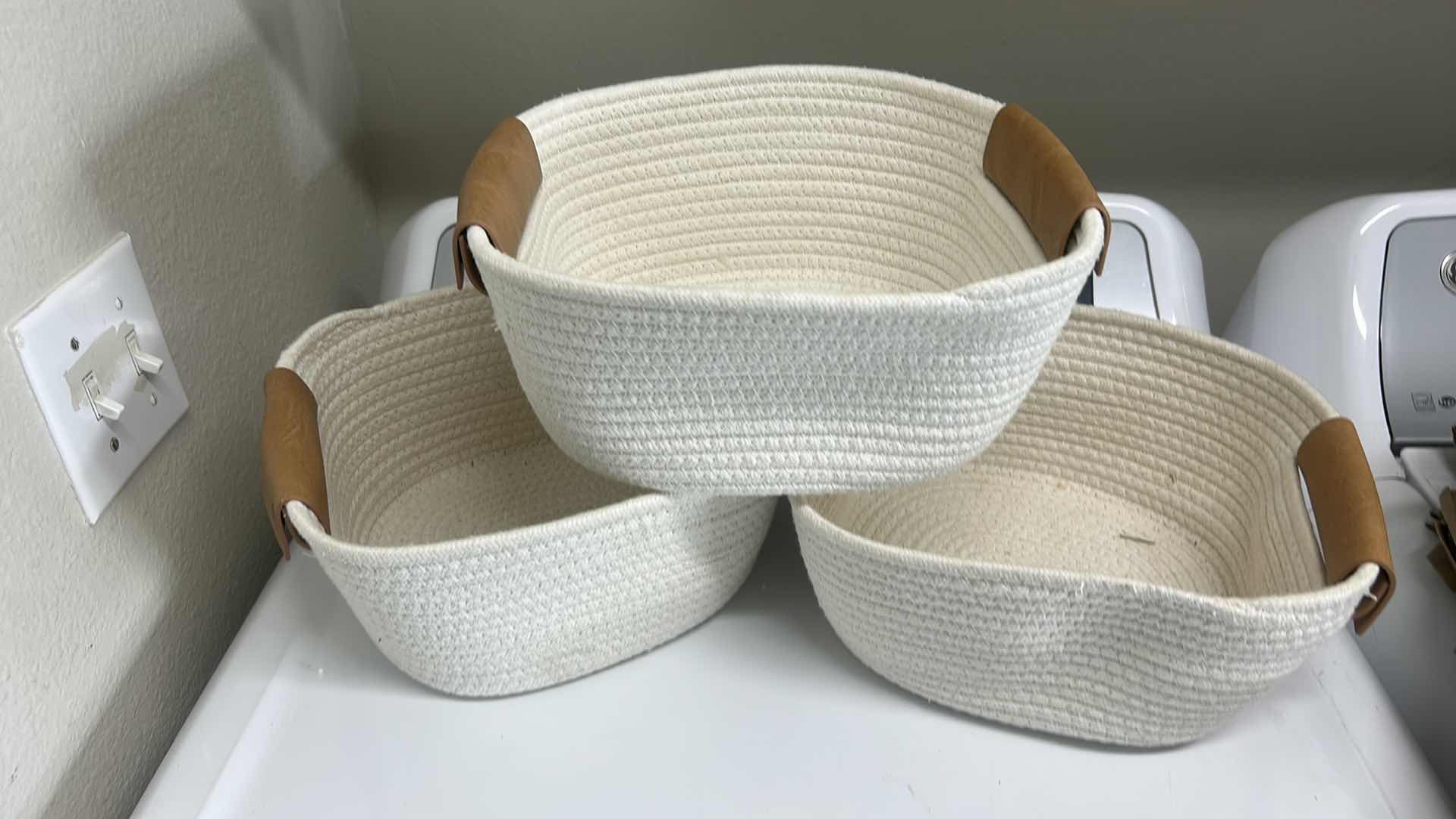 Photo 1 of 3 WOVEN BASKETS 10 1/2” x 10 1/2” x 5” AND 1 METAL BASKET WITH 2 LIDDED JARS